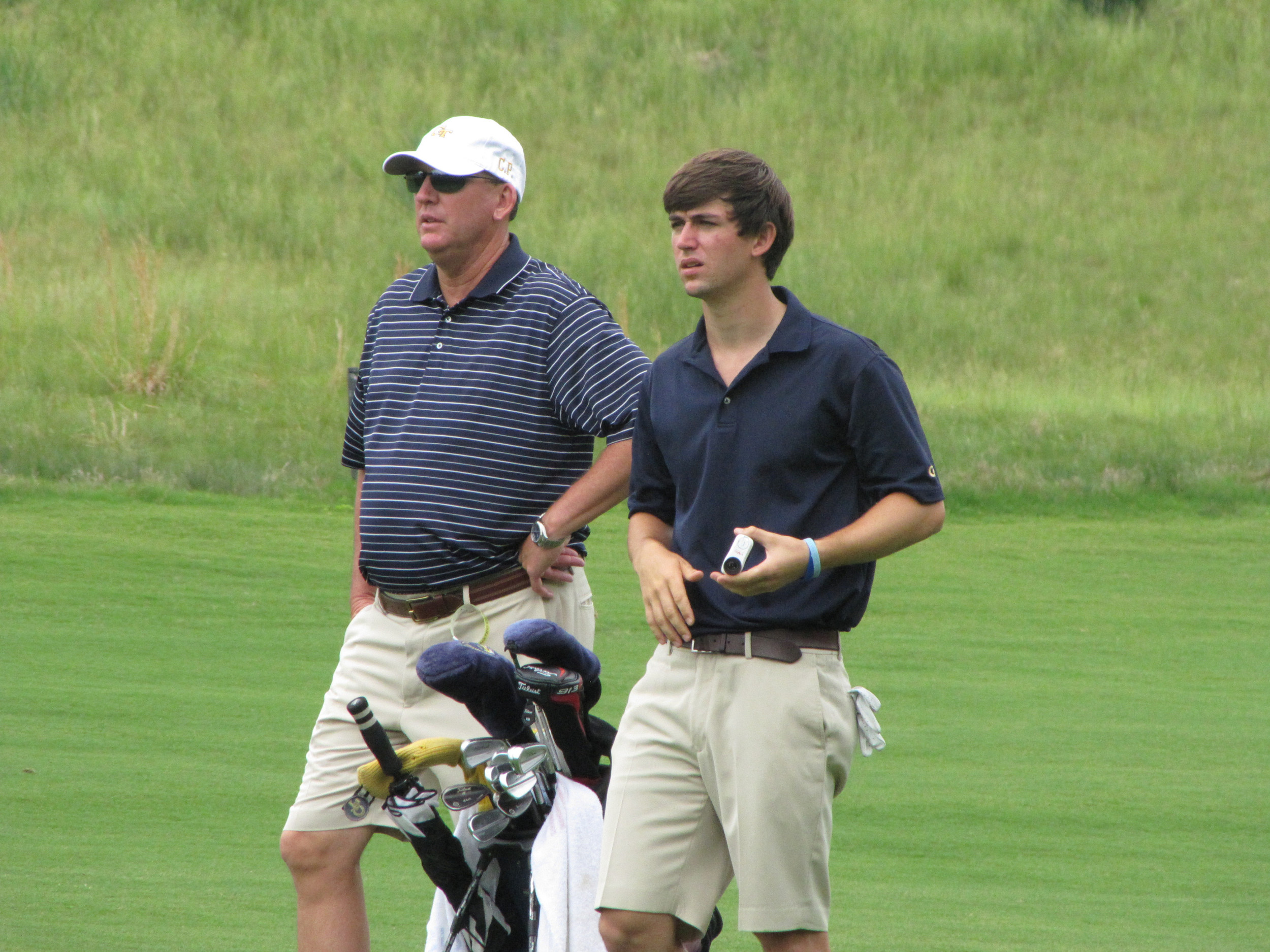 Head coach Bruce Heppler and Ollie Schniederjans assess his second shot at the 9th hole during the first round of the NCAA Raleigh Regional, May 15, 2014