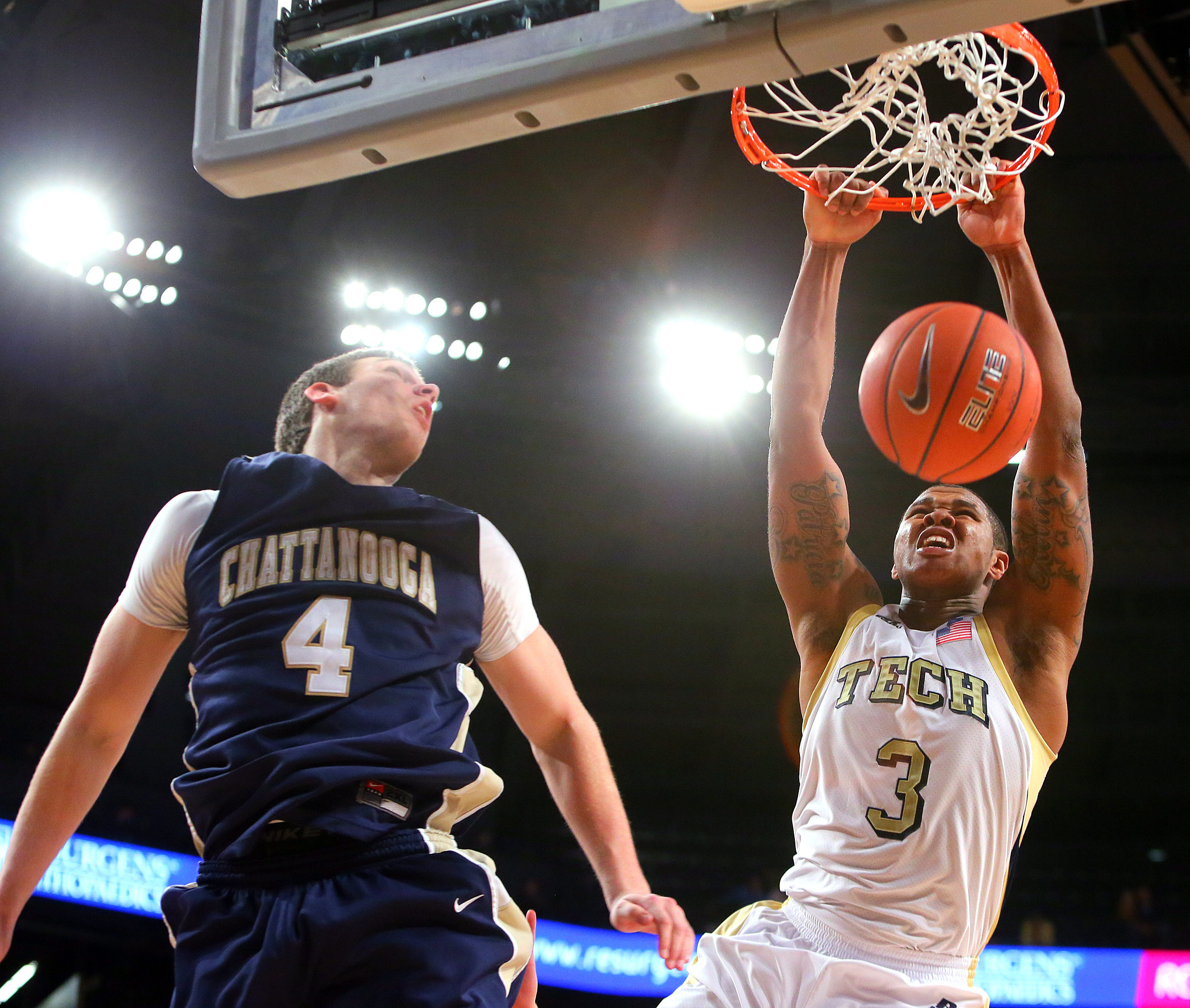 Georgia Tech guard Marcus Georges-Hunt, right, slams for two of his 16 points past Chattanooga defender Sam Watson. (AP Photo/Atlanta Journal & Constitution, Curtis Compton)