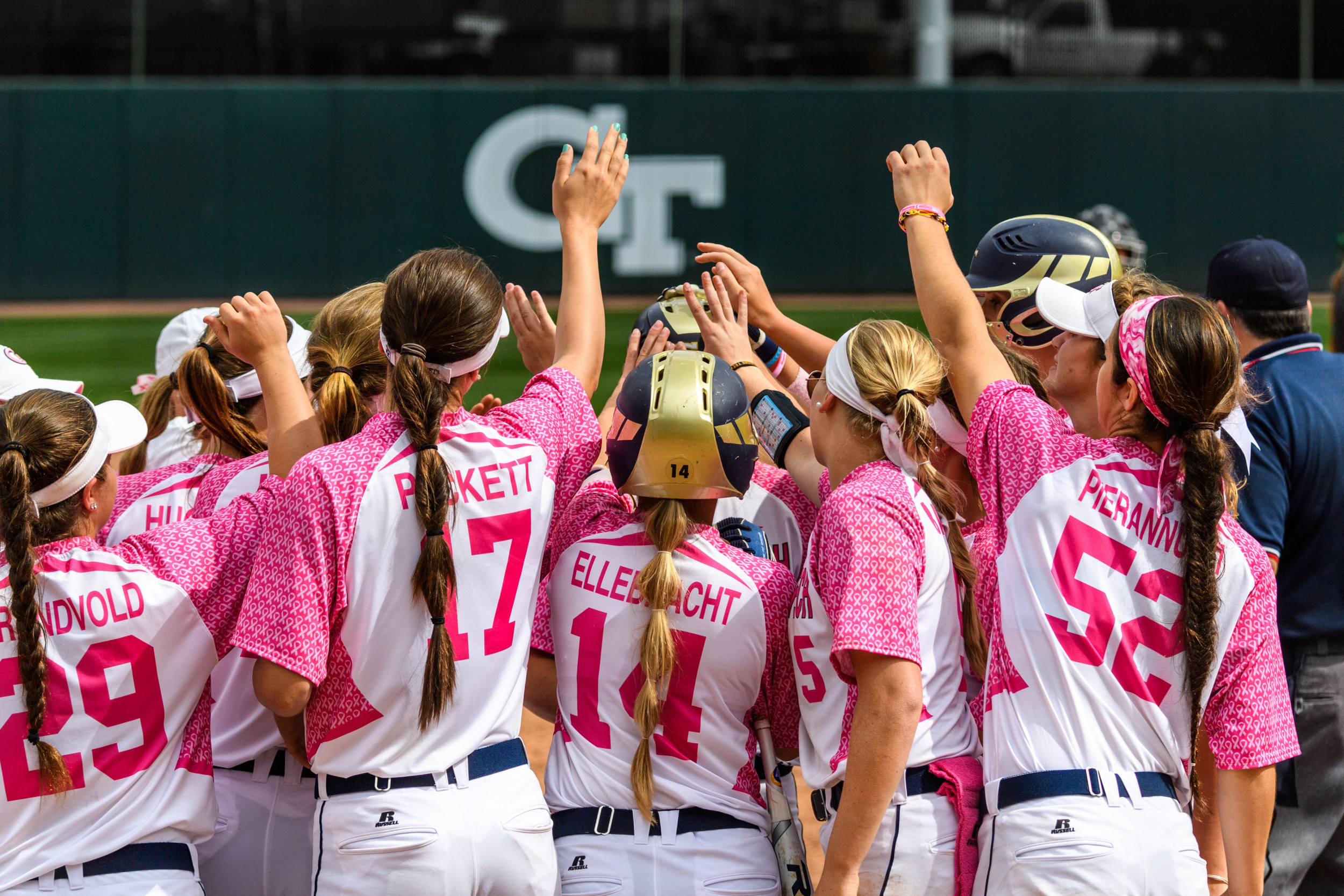 The team meets Rebecca Prairie (4) at home plate after her home run