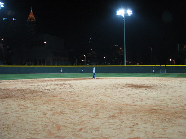Softball team practices at night for the first time in its new stadium.