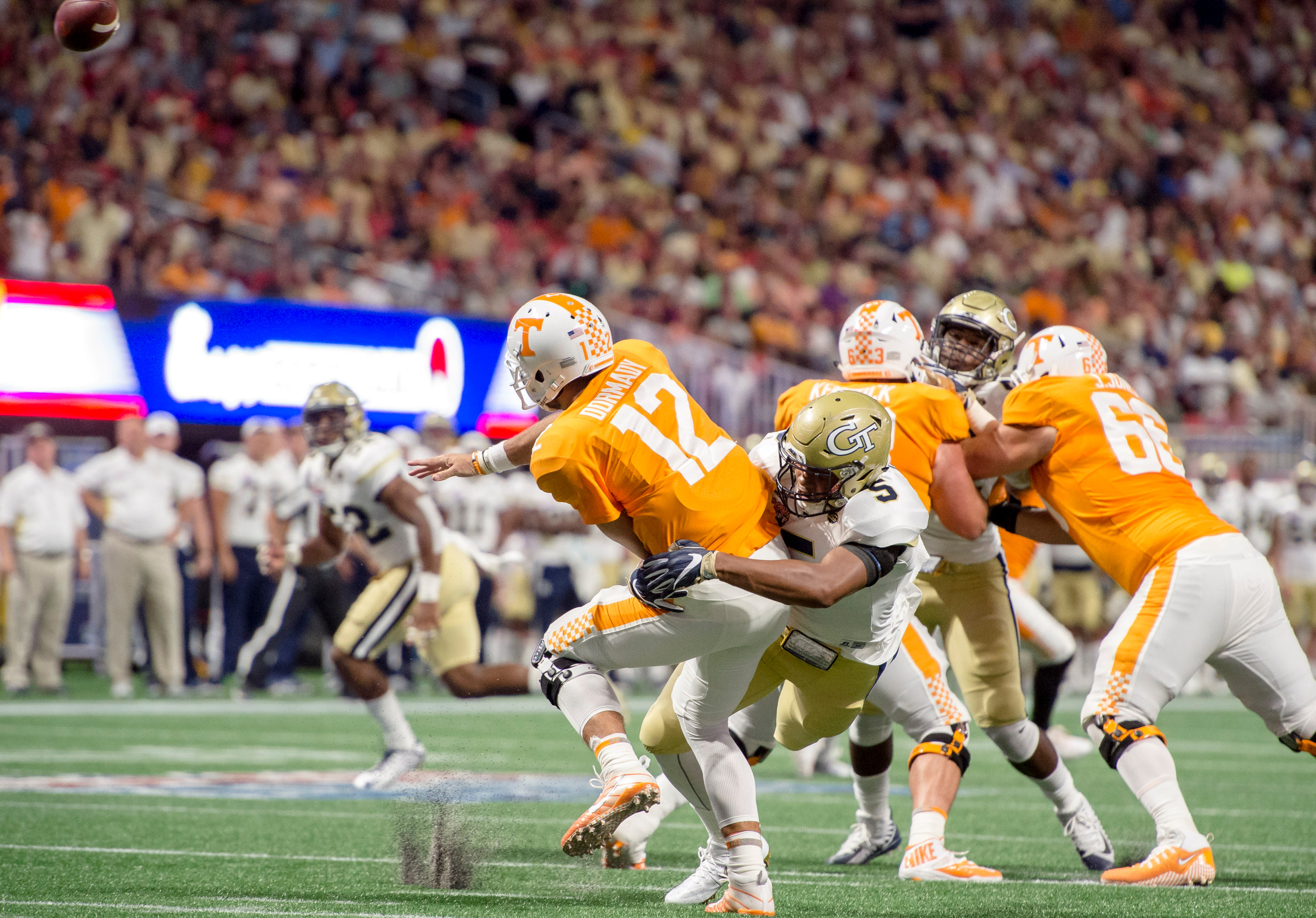 defensive player taking down UT QB Quinten Dormady