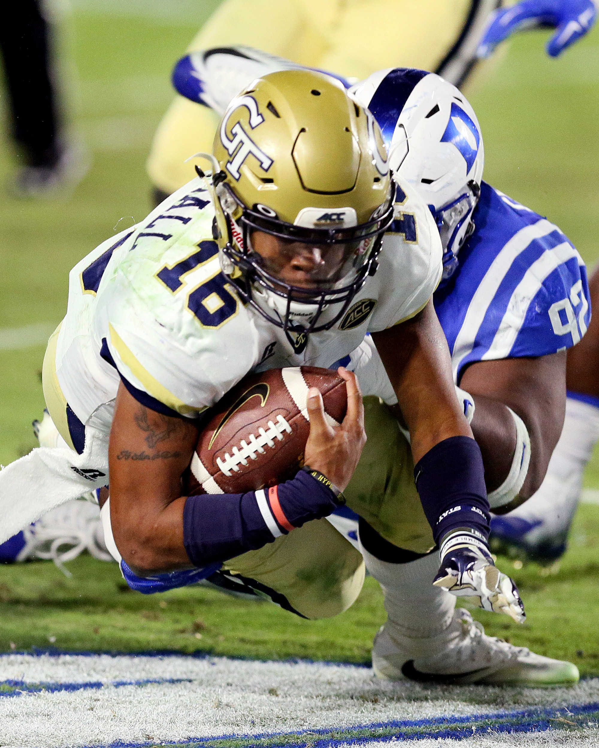 Nov 18, 2017; Durham, NC, USA; Georgia Tech Yellow Jackets quarterback TaQuon Marshall (16) lunges for extra yards as he is tackled by Duke Blue Devils defensive tackle Edgar Cerenord (92) in the second half at Wallace Wade Stadium. Duke beat the Georgia Tech 42-20. Mandatory Credit: Mark Dolejs-USA TODAY Sports