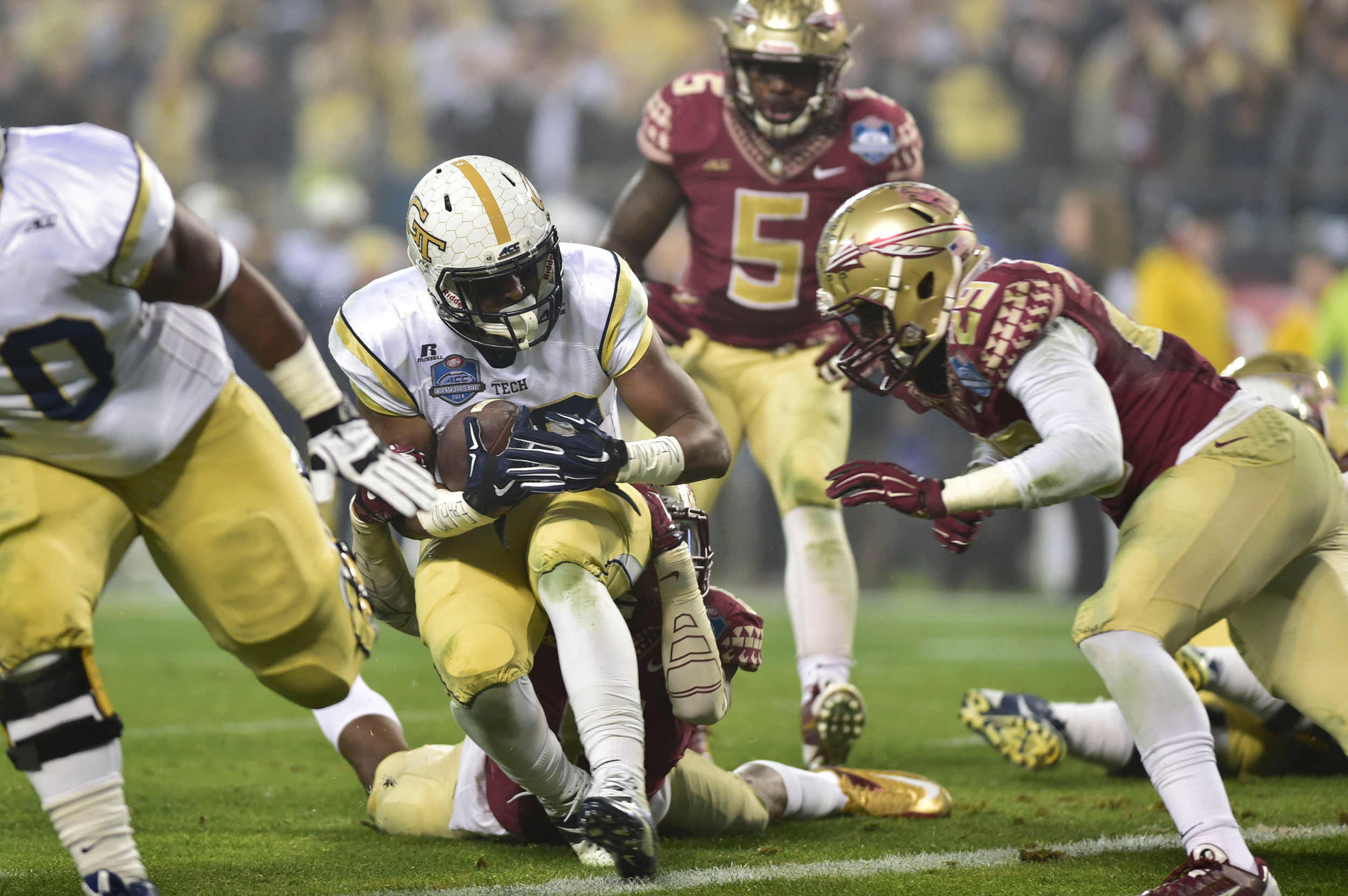 Dec 6, 2014; Charlotte, NC, USA; Georgia Tech Yellow Jackets running back Synjyn Days (10) scores a touchdown as Florida State Seminoles defensive back Nate Andrews (29) defends in the first quarter at Bank of America Stadium. Mandatory Credit: Bob Donnan-USA TODAY Sports
