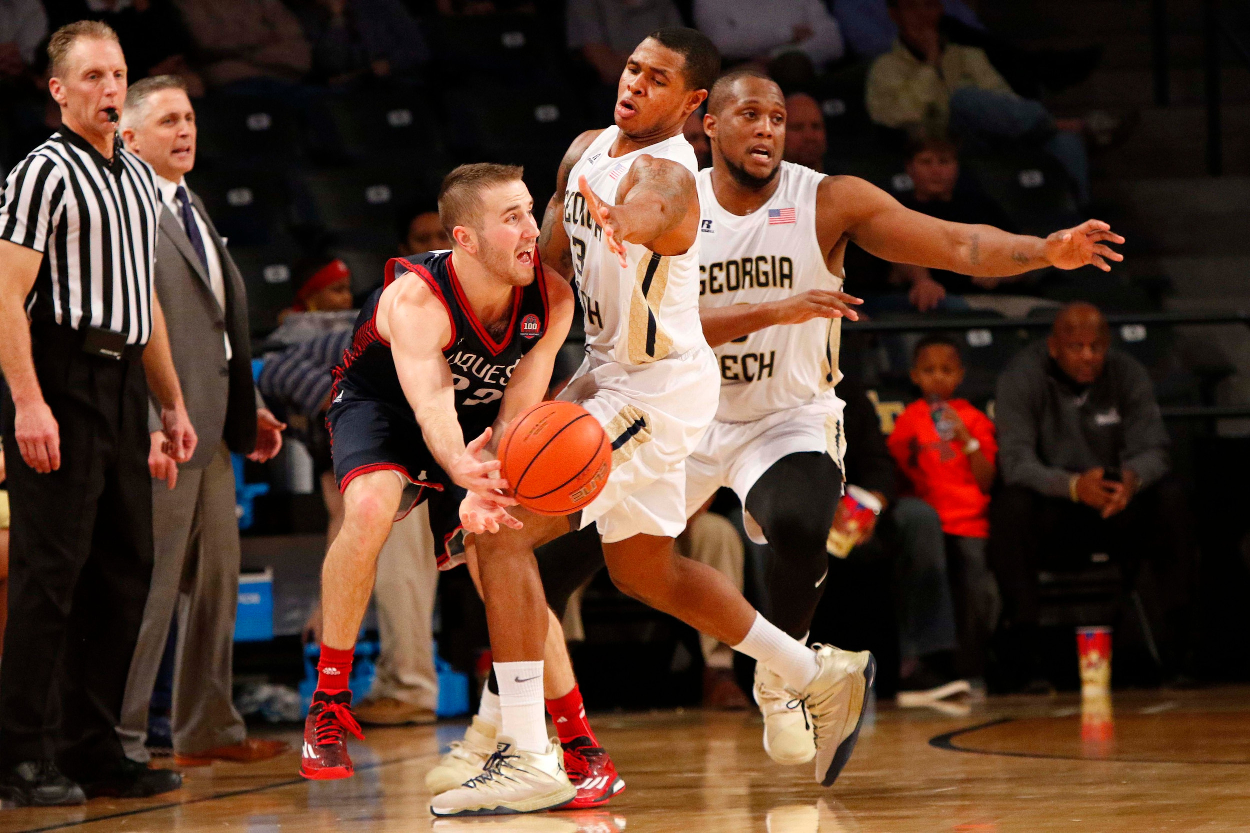 Dec 29, 2015; Atlanta, GA, USA; Duquesne Dukes guard Micah Mason (22) is defended by Georgia Tech Yellow Jackets guard Marcus Georges-Hunt (3) and forward Charles Mitchell (0). Credit: Brett Davis-USA TODAY Sports