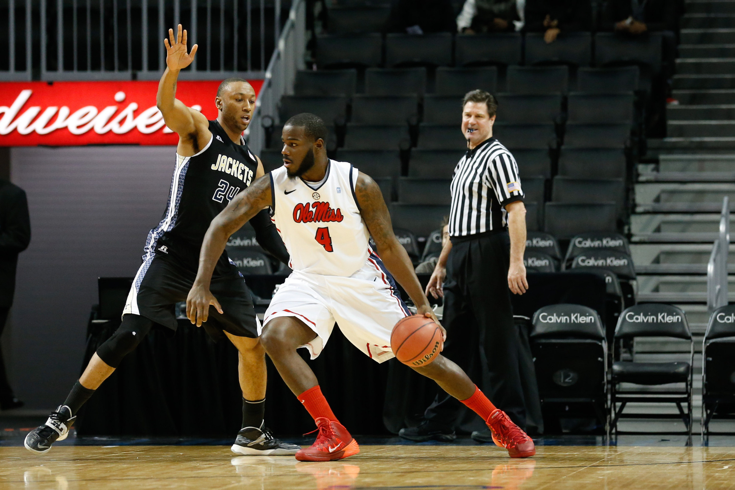 Nov 29, 2013; Brooklyn, NY, USA; Mississippi Rebels center Demarco Cox (4) drives through Georgia Tech Yellow Jackets forward Kammeon Holsey (24) during the first half at Barclays Center. Mandatory Credit: Anthony Gruppuso-USA TODAY Sports