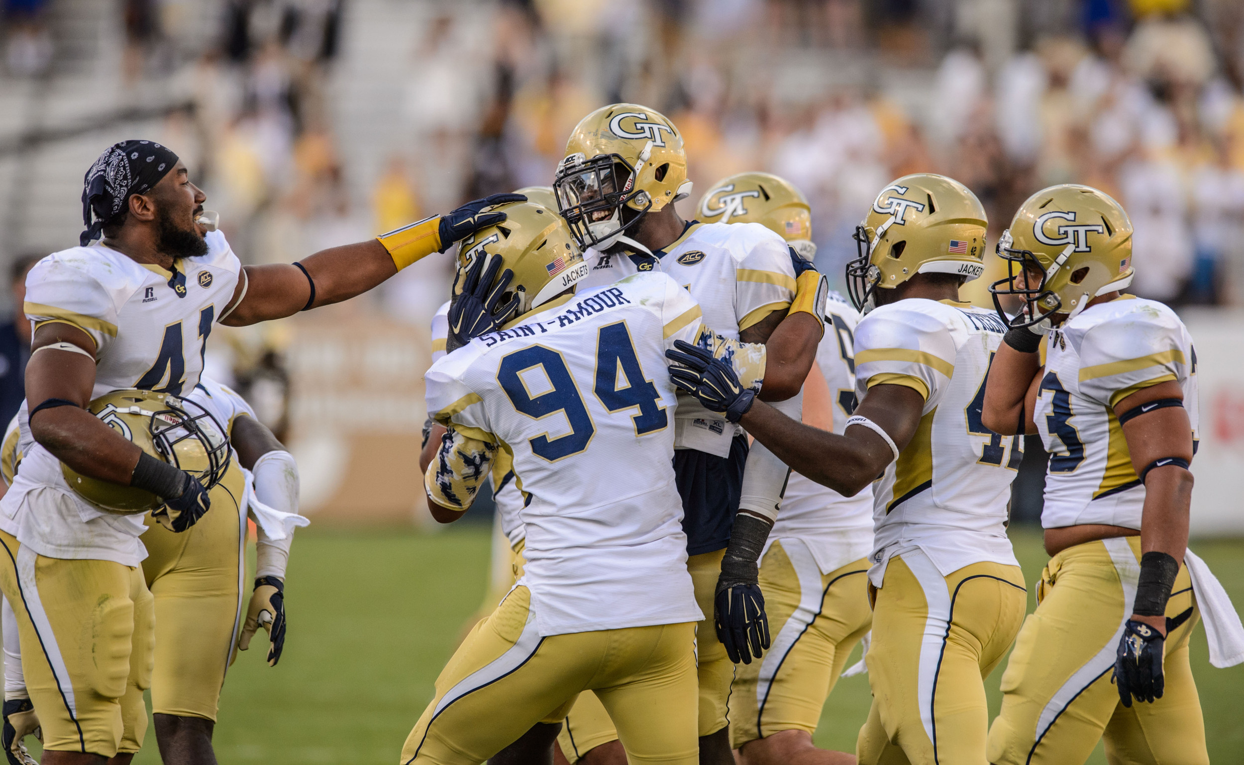 The Jackets celebrate Anree Saint-Amour's (94) fumble recovery.