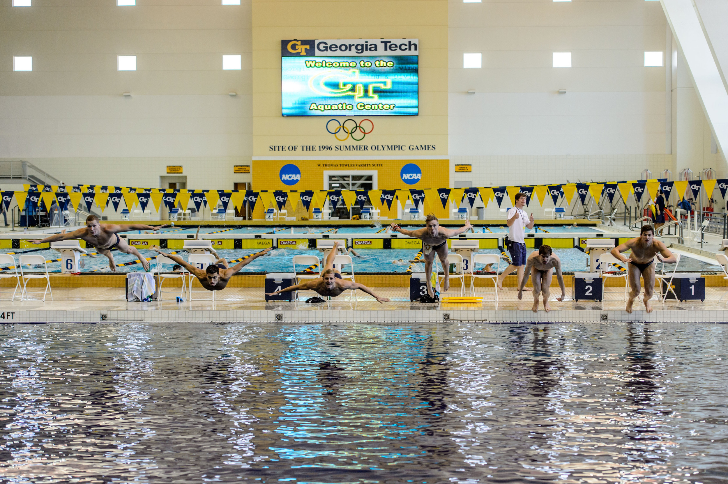 Seniors Elliott Brockelbank, Andrew Chetcuti, Dylan Kase, Andrew Kosic, Mark Sarman, and Nico van Duijn leap into the pool at the end of the meet