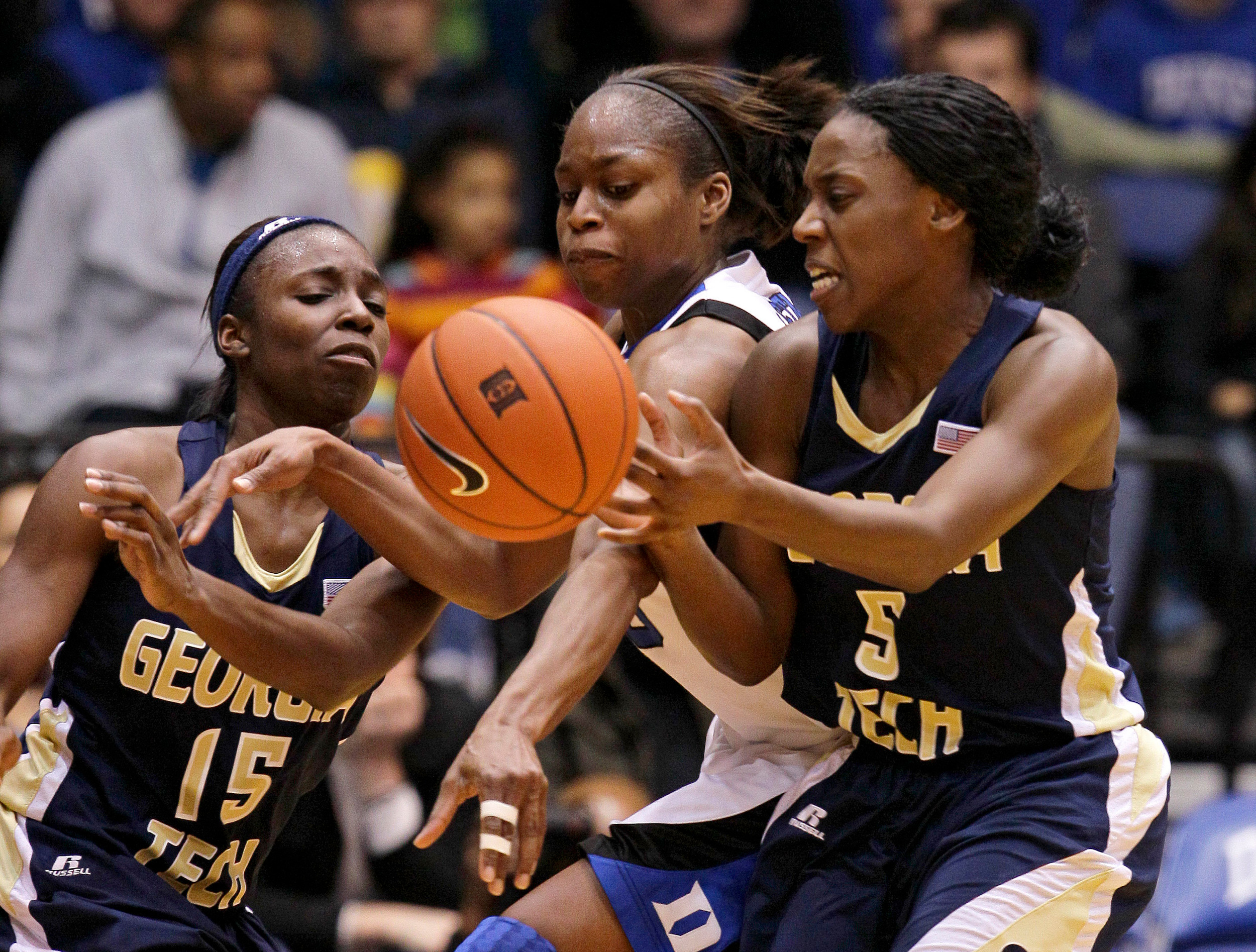 Duke's Karima Christmas, center, fights for possession of the ball with Georgia Tech's Tyaunna Marshall (15) and Metra Walthour (5) during the first half of an NCAA college basketball game in Durham, N.C., Friday, Jan. 21, 2011. (AP Photo/Gerry Broome)