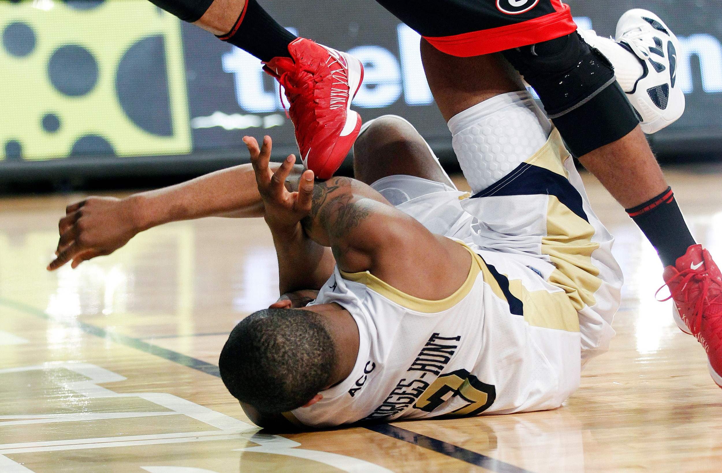 Georgia Tech's Marcus Georges-Hunt (3) is stepped on after falling on the court during the second half. (AP Photo/John Bazemore)