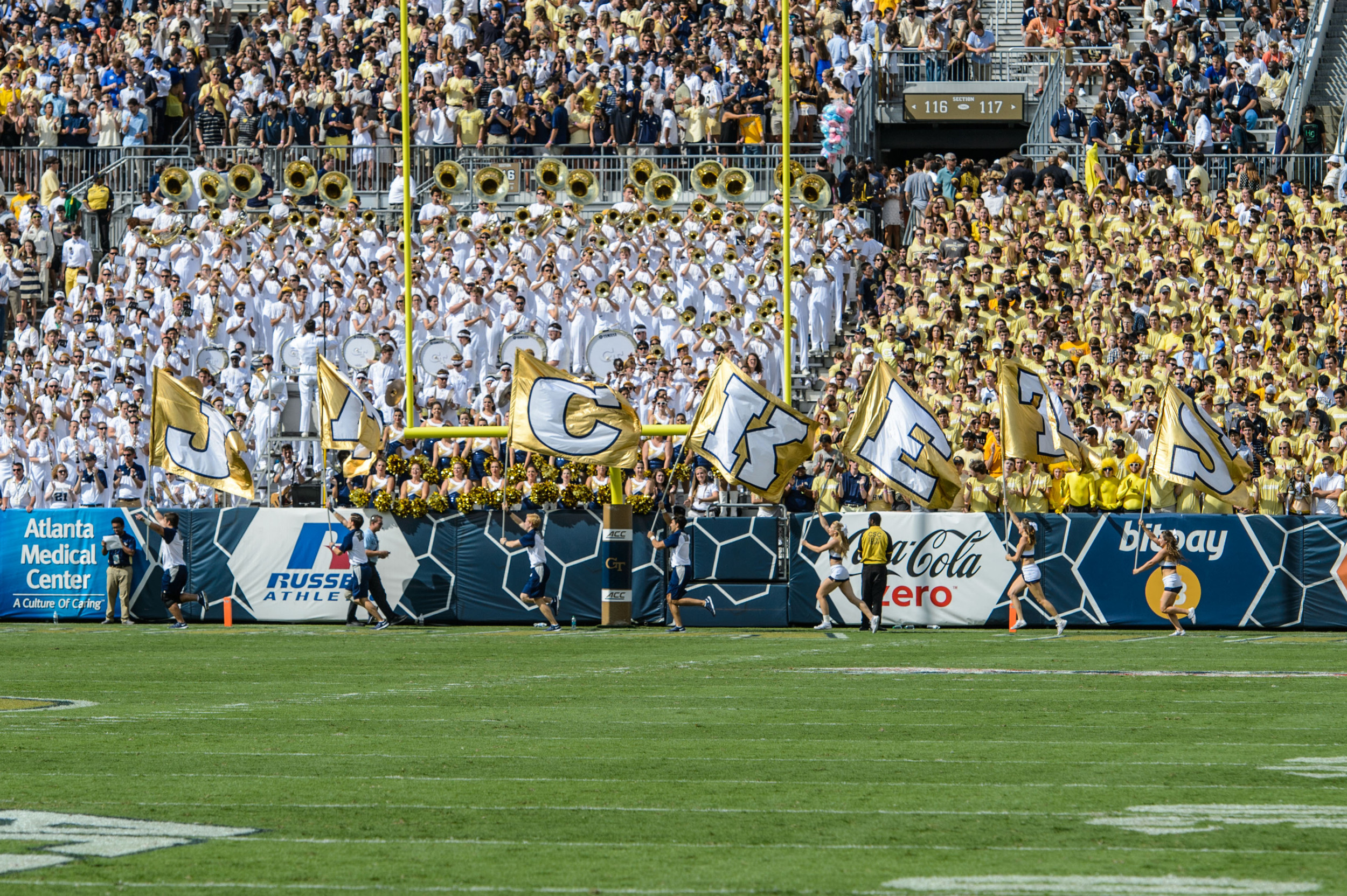 Cheerleaders run the JACKETS flags after the score