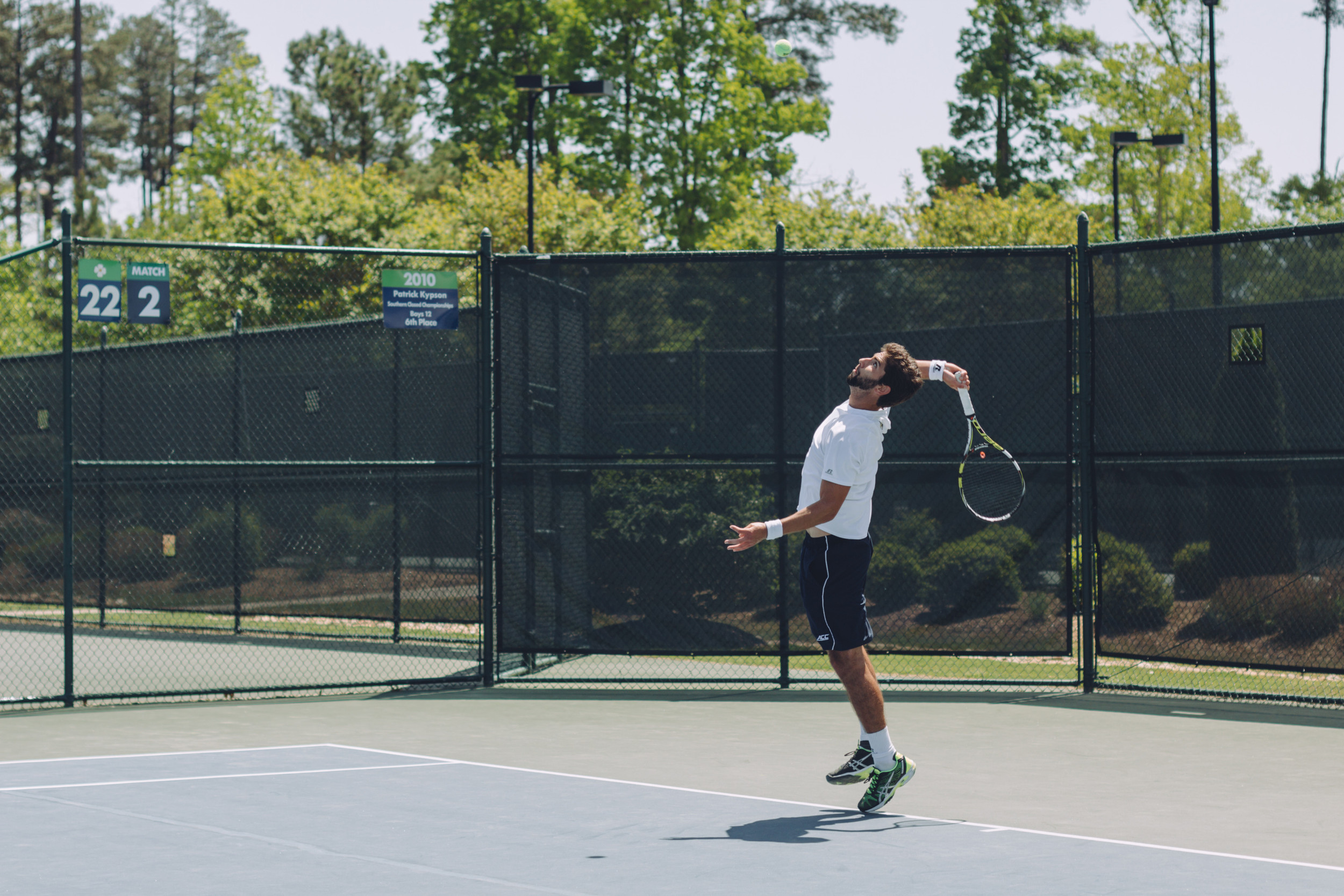 Carlos Benito serves an ace as he played for the match-winning point on court two against Virginia Tech.