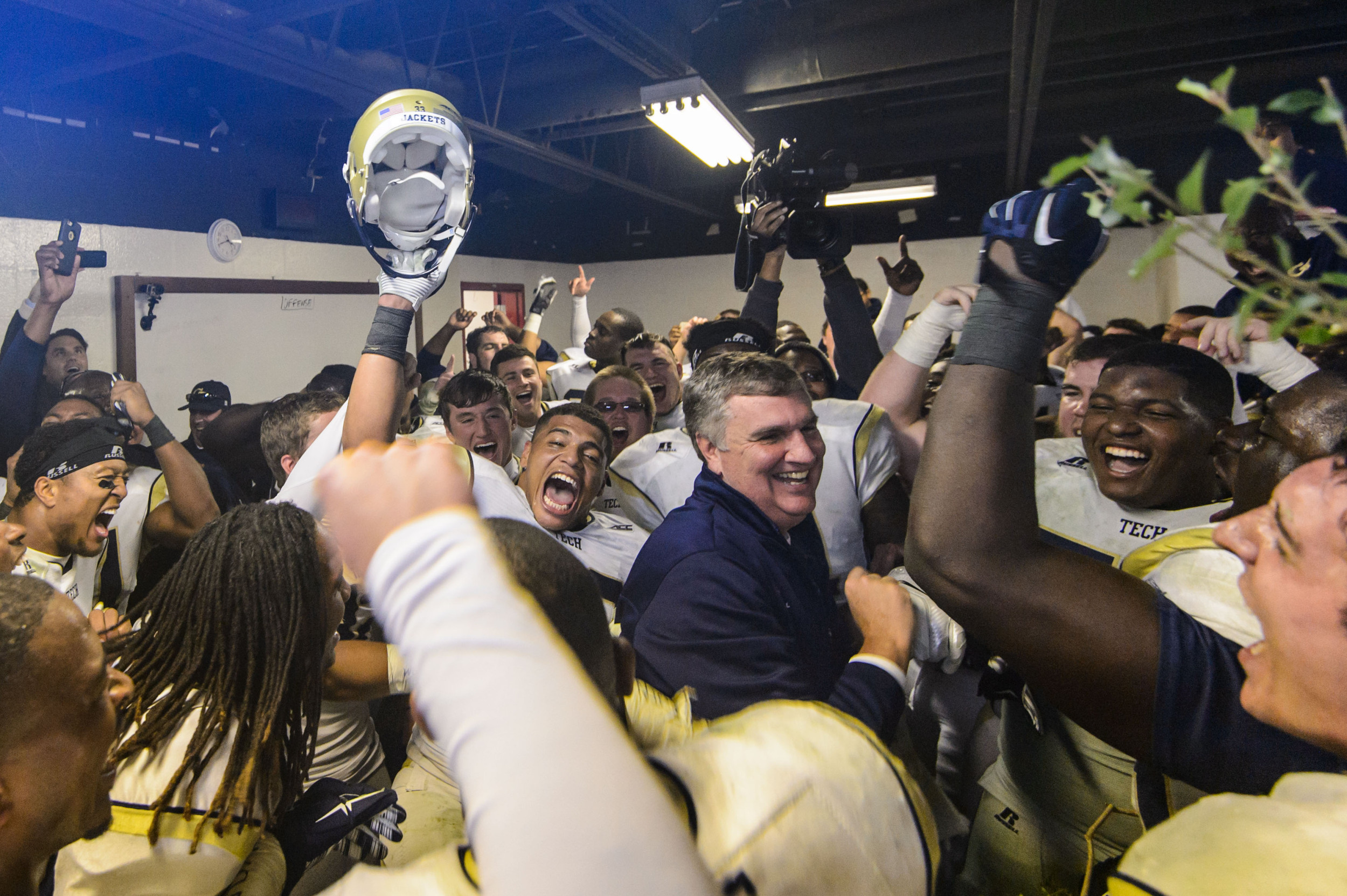 Coach Johnson and the team celebrate the big win over UGA in the locker room