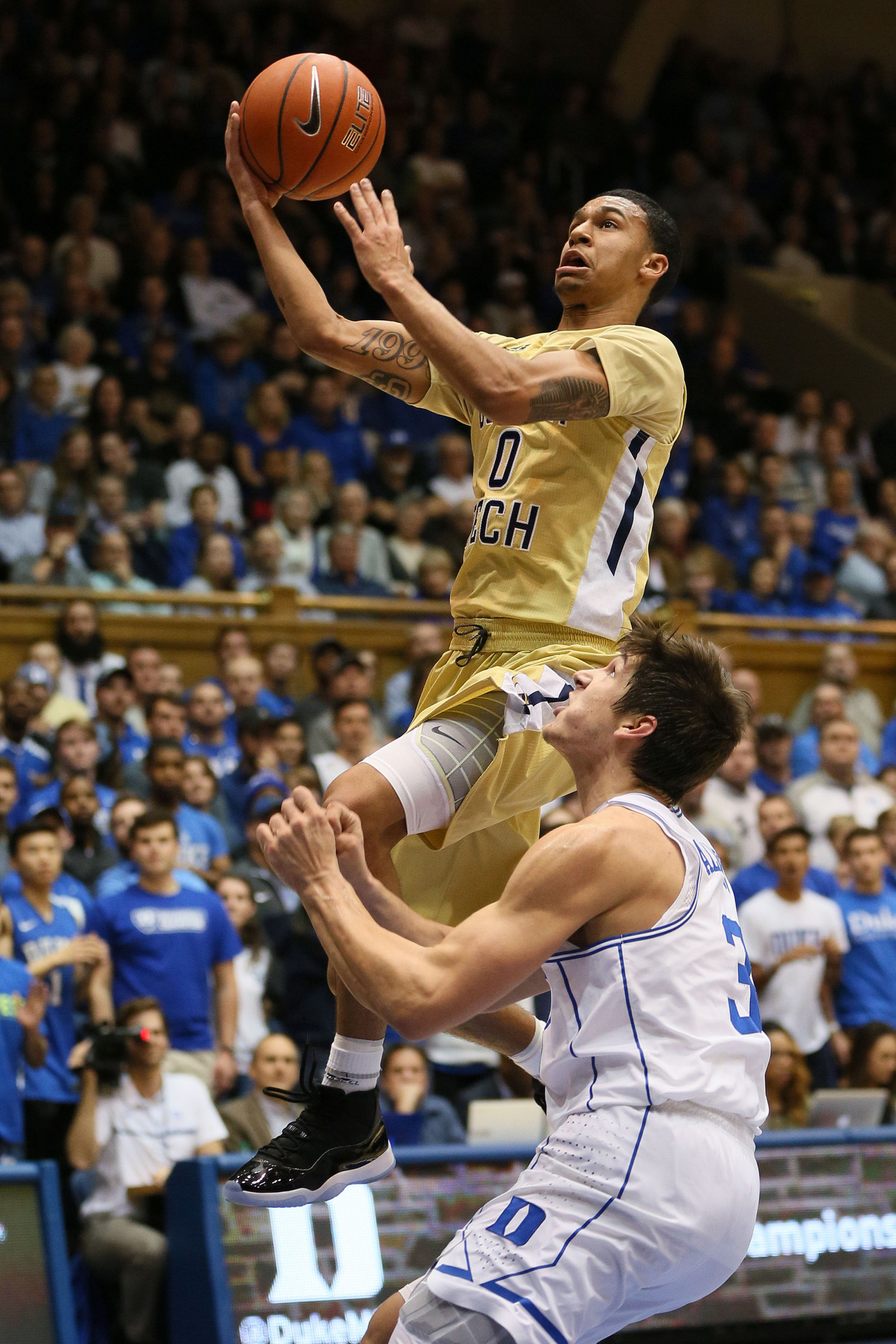 Jan 4, 2017; Justin Moore (0) drives against Duke Blue Devils guard Grayson Allen (3) in the first half of their game at Cameron Indoor Stadium. Credit: Mark Dolejs-USA TODAY Sports