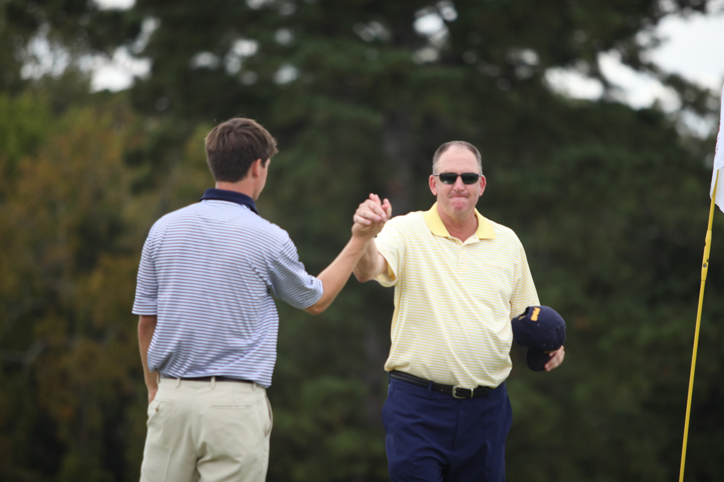 Head coach Bruce Heppler congratulates Ollie Schniederjans after the final round of the 2013 Brickyard Collegiate.