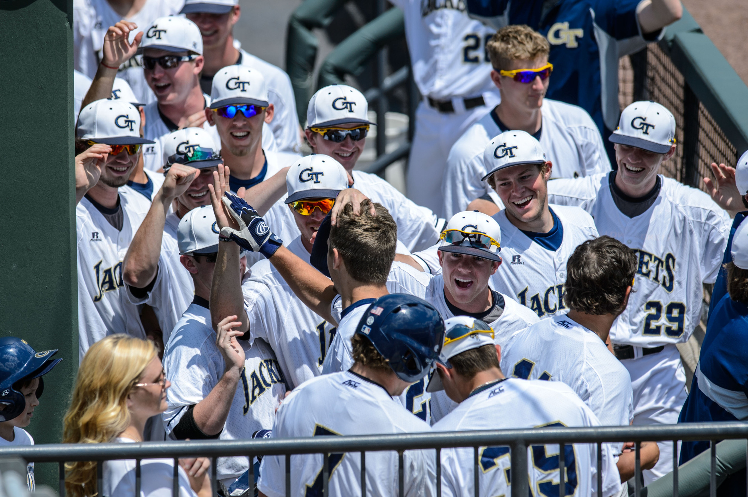 Kel Johnson (25) is welcomed back to the dugout after hitting a home run
