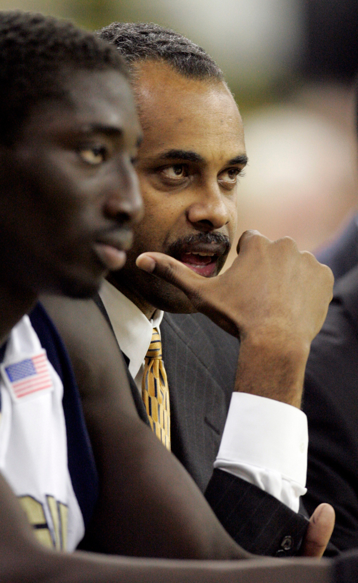 Georgia Tech head coach Paul Hewitt, right, talks with Mouhammad Faye as the two sit on the bench during the second half of a college basketball game against Centenary Monday, Dec. 18, 2006, in Atlanta. Georgia Tech won 92-52. (AP Photo/Todd Bennett)