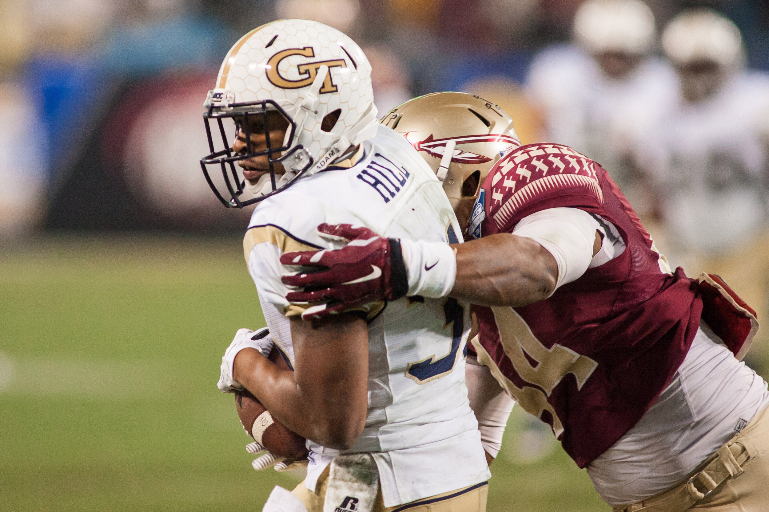 Dec 6, 2014; Charlotte, NC, USA; Georgia Tech Yellow Jackets running back Deon Hill (31) catches a pass while being defended by Florida State Seminoles defensive end DeMarcus Walker (44) during the second quarter at Bank of America Stadium. Mandatory Credit: Jeremy Brevard-USA TODAY Sports