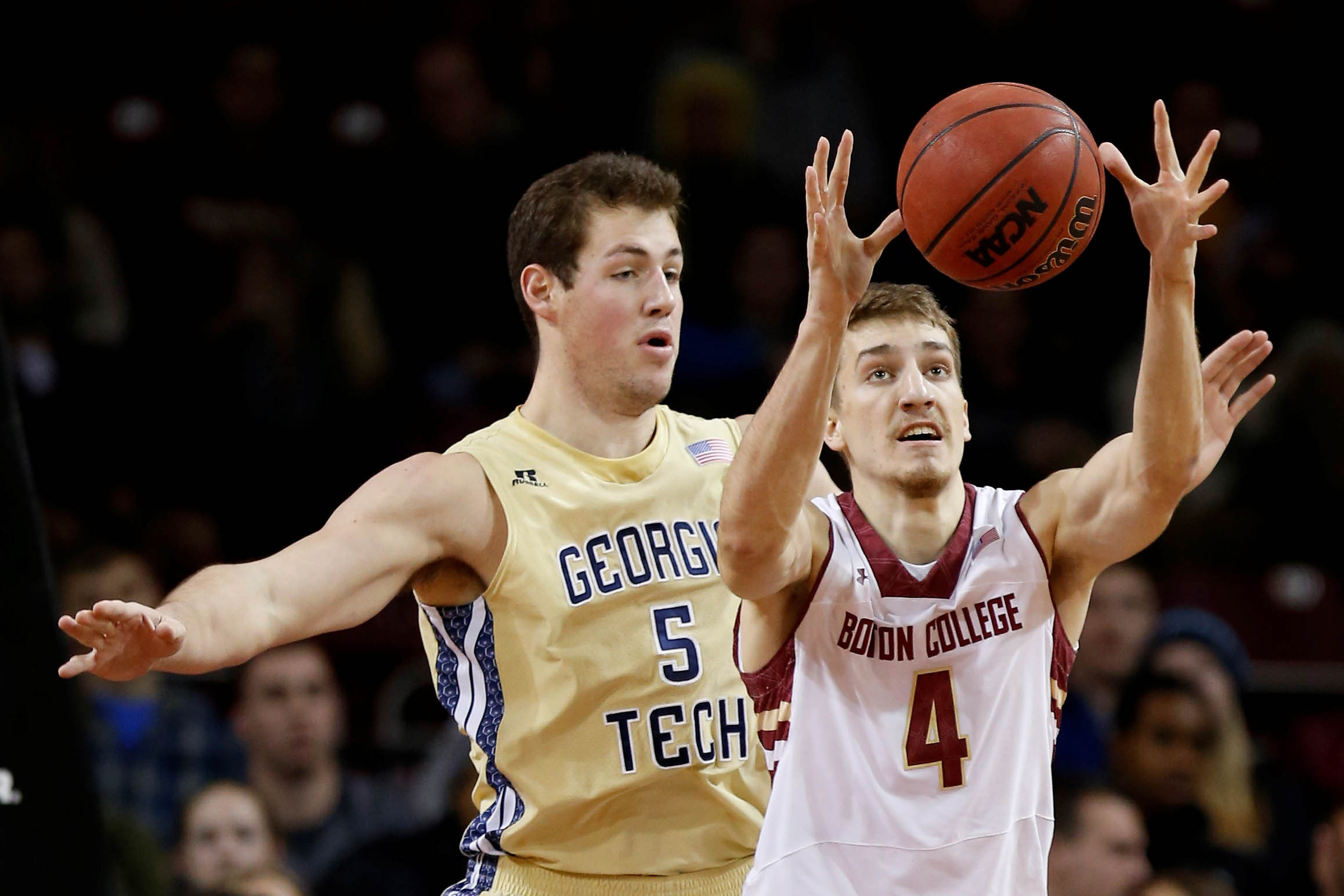 Jan 21, 2014; Chestnut Hill, MA, USA; Boston College Eagles forward Eddie Odio (4) grabs a pass in front of Georgia Tech Yellow Jackets center Daniel Miller (5) during the first half at Silvio O. Conte Forum. Mandatory Credit: Greg M. Cooper-USA TODAY Sports
