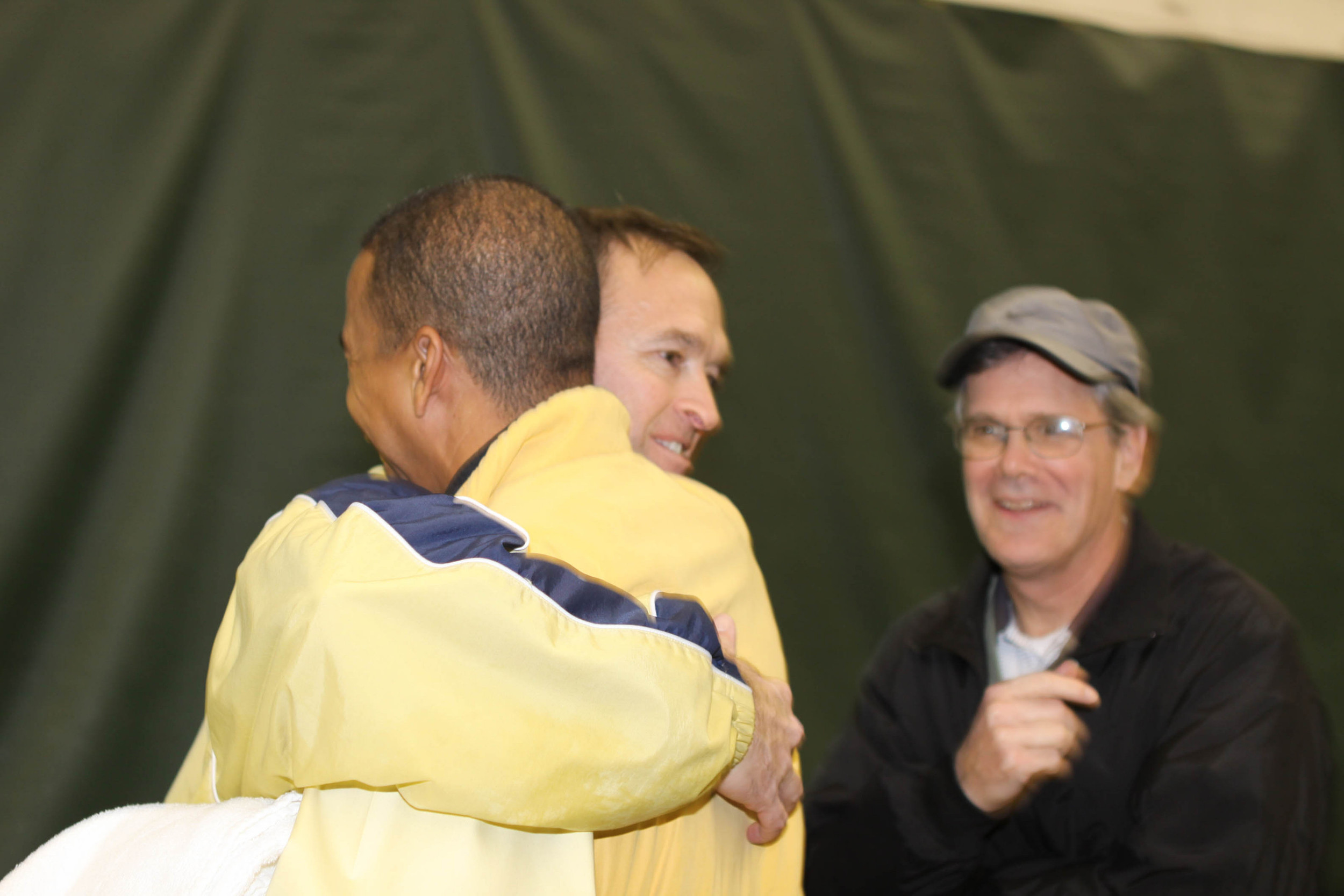 Georgia Tech head coaches Kenny Thorne and Bryan Shelton embrace. The last time Tech beat Georgia, the two were seniors on the Tech men's tennis team in 1988