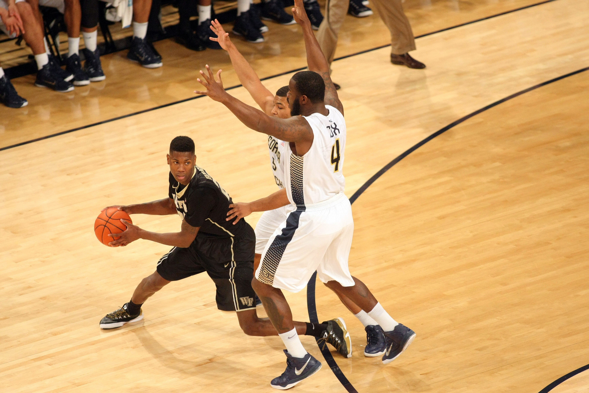 Feb 7, 2015; Atlanta, GA, USA; Wake Forest Demon Deacons forward Cornelius Hudson (25) is defended by Georgia Tech Yellow Jackets guard Corey Heyward (5) and center Demarco Cox (4) in the first half at McCamish Pavilion. Mandatory Credit: Brett Davis-USA TODAY Sports