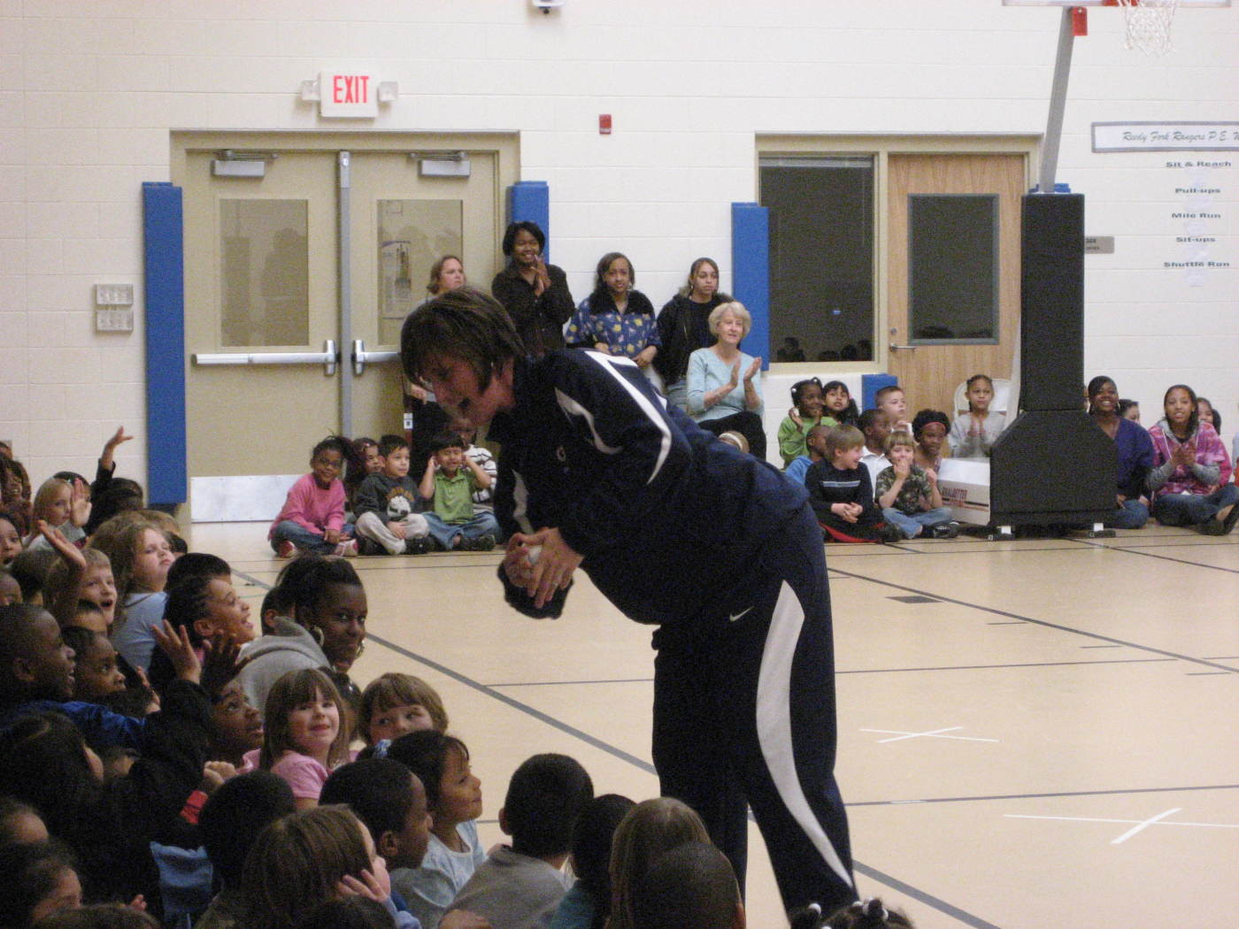 Coach Moren hands out a mini basketball to a special student