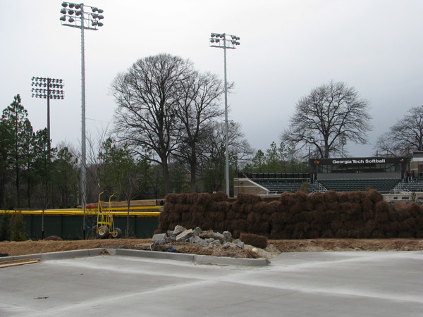Work continues on the parking lot behind center and right fields. Shrubbery is also planted behind the outfield fence.