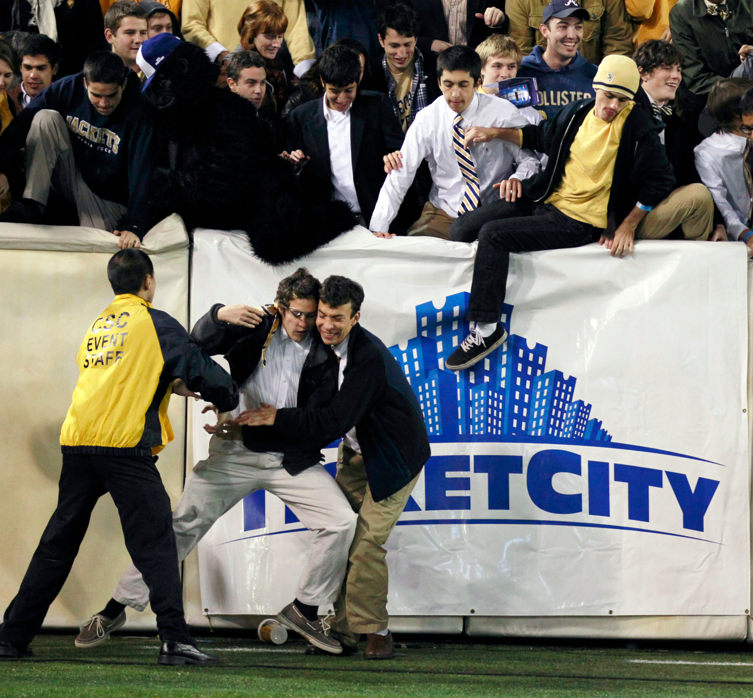 Georgia Tech fans rush the field after the Yellow Jackets defeated Clemson. (AP Photo/John Bazemore)