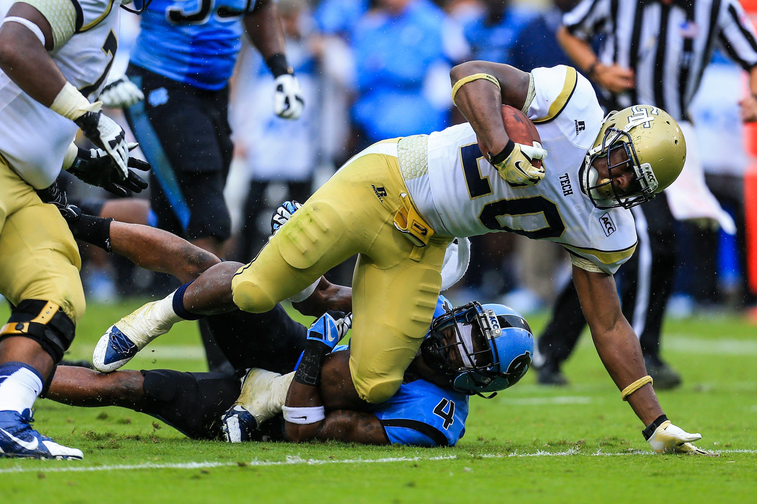 Sep 21, 2013; Atlanta, GA, USA; Georgia Tech Yellow Jackets running back David Sims (20) runs through a tackle by North Carolina Tar Heels cornerback Jabari Price (4) in the first half at Bobby Dodd Stadium. Mandatory Credit: Daniel Shirey-USA TODAY Sports
