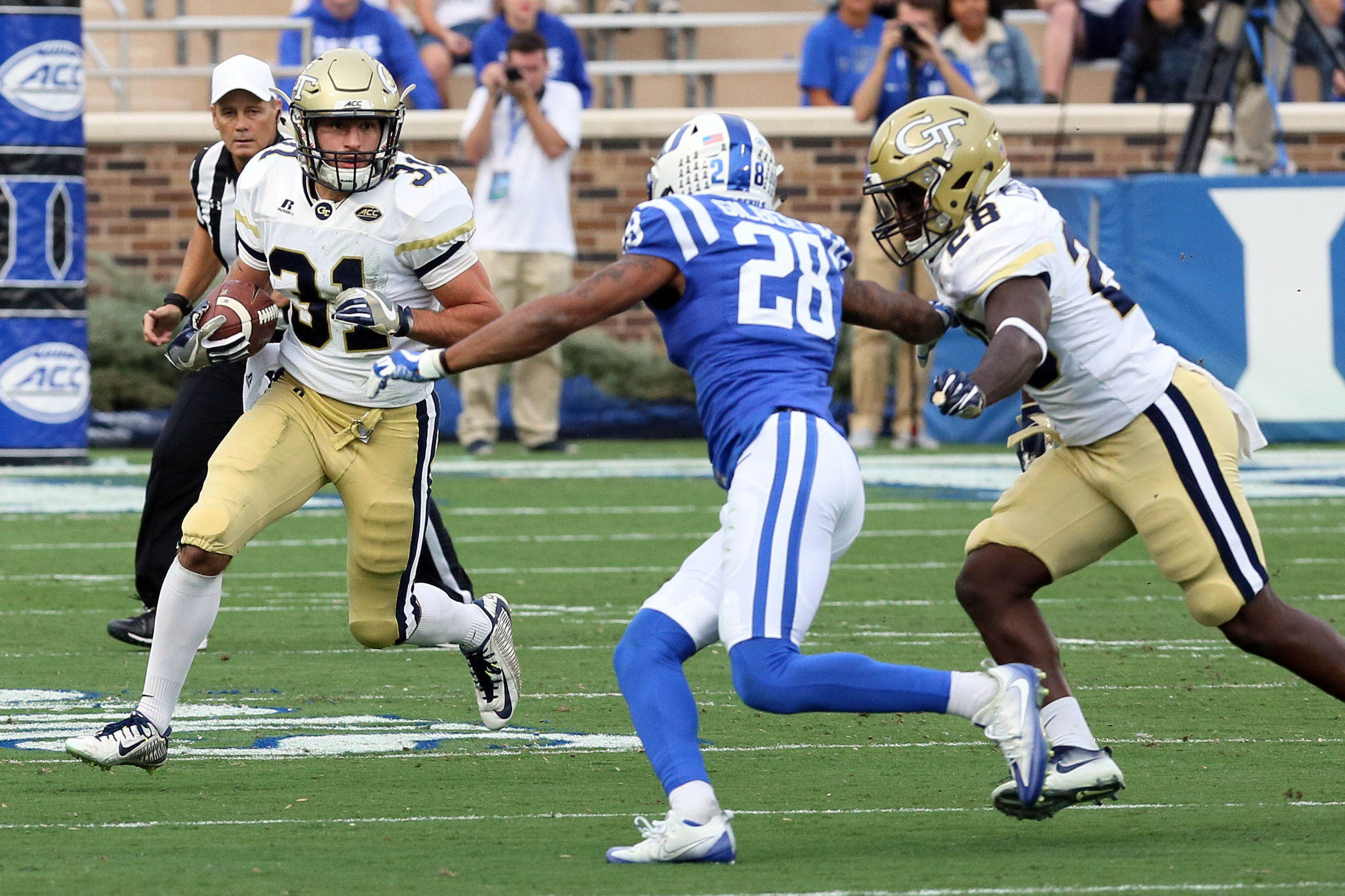 Nov 18, 2017; Durham, NC, USA; Georgia Tech Yellow Jackets running back Nathan Cottrell (31) runs the ball as Duke Blue Devils cornerback Mark Gilbert (28) looks for the tackle in the first half at Wallace Wade Stadium. Mandatory Credit: Mark Dolejs-USA TODAY Sports