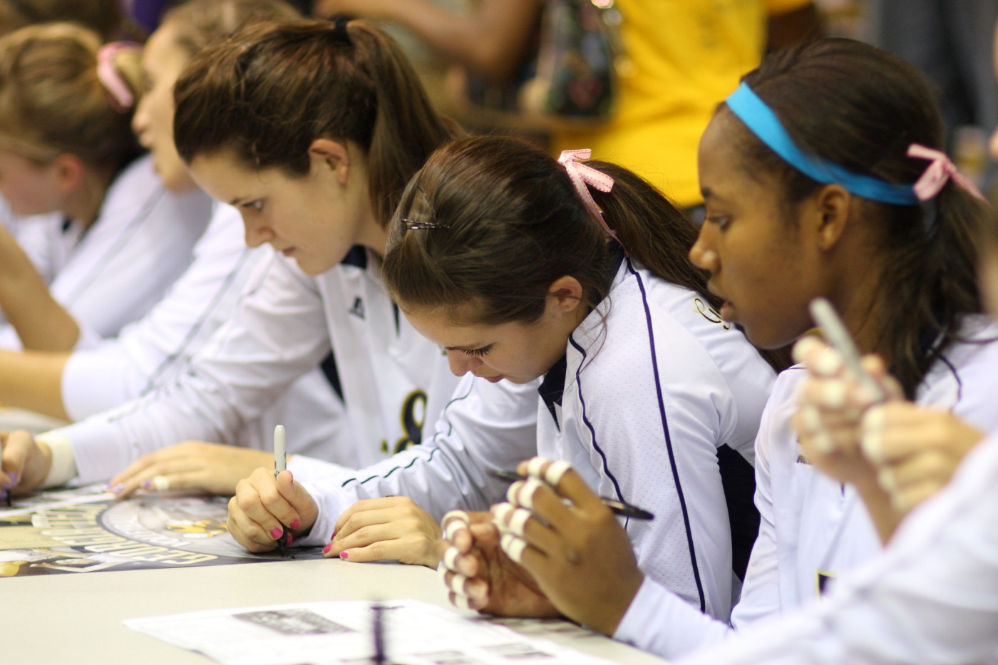 Team signs autographs after match.