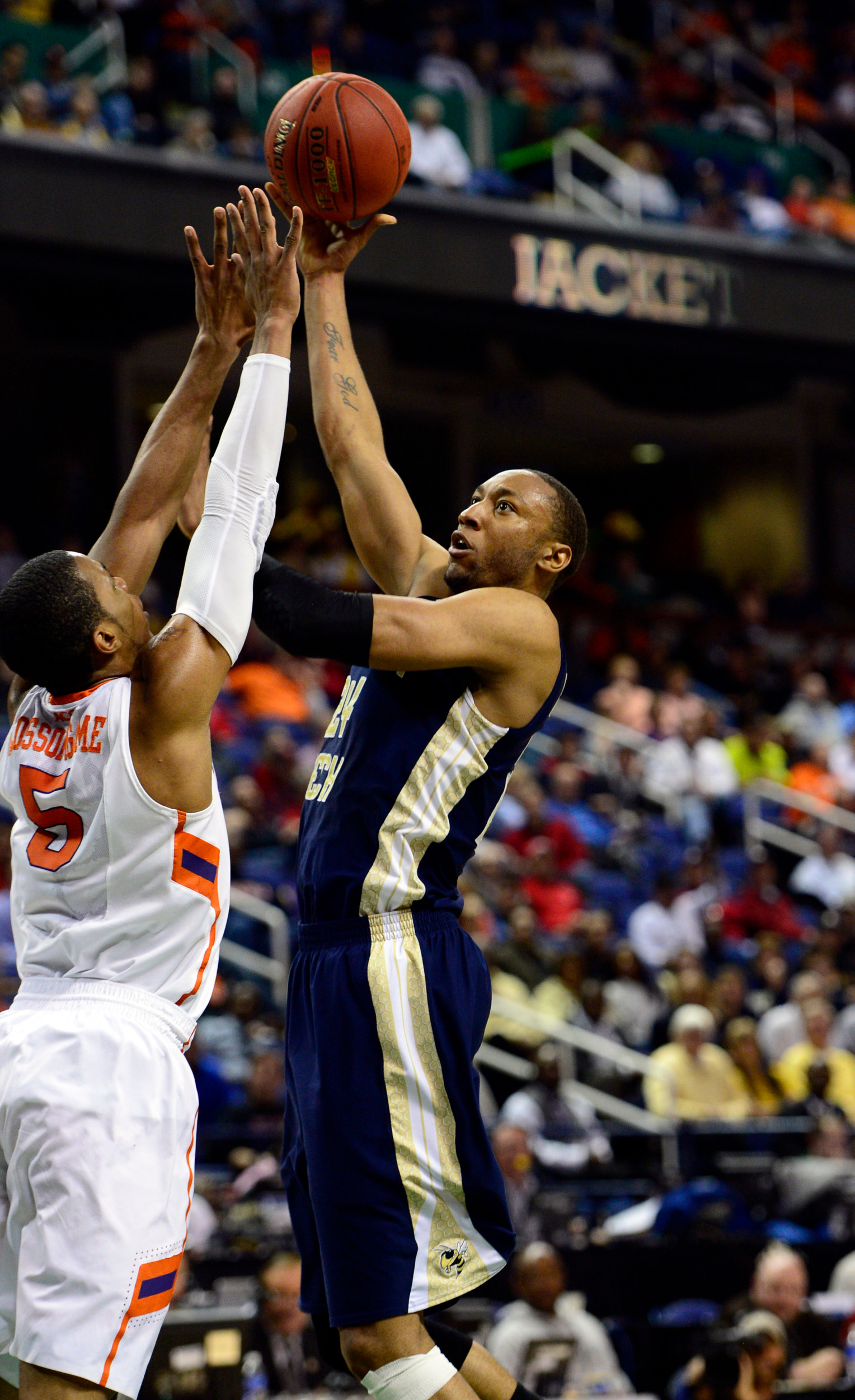 Mar 13, 2014; Greensboro, NC, USA; Georgia Tech Yellow Jackets forward Kammeon Holsey (24) takes a shot over Clemson Tigers forward Jaron Blossomgame (5) in the second round of the ACC college basketball tournament at Greensboro Coliseum. Mandatory Credit: John David Mercer-USA TODAY Sports