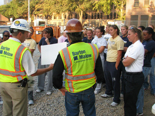 The team is shown drawings of what the finished product will look like.