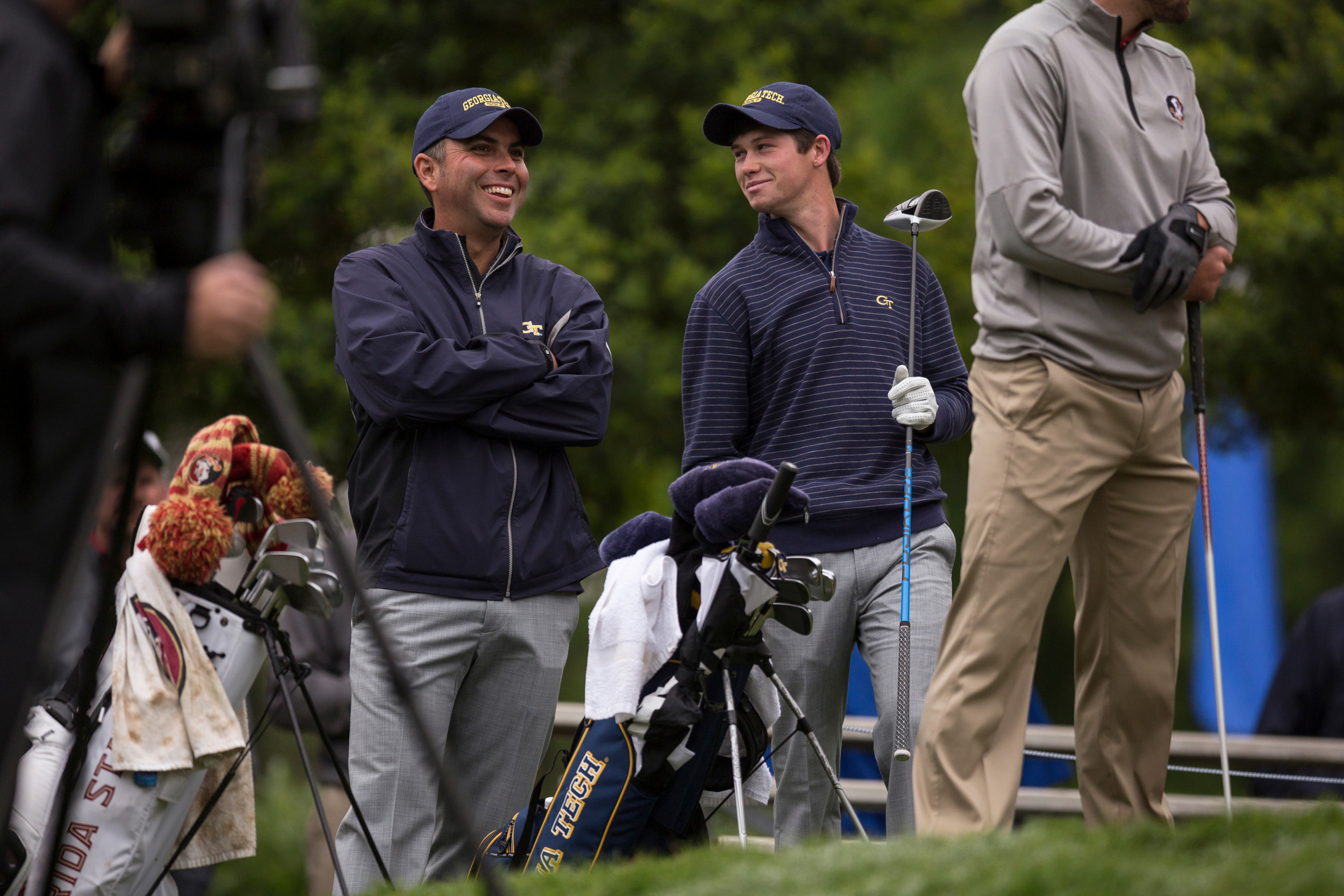 Associate head coach Brennan Webb and James Clark watch their teammates by the 18th green during the playoff of the ACC Golf Championship, April 26, 2015, Old North State Club, New London, N.C.