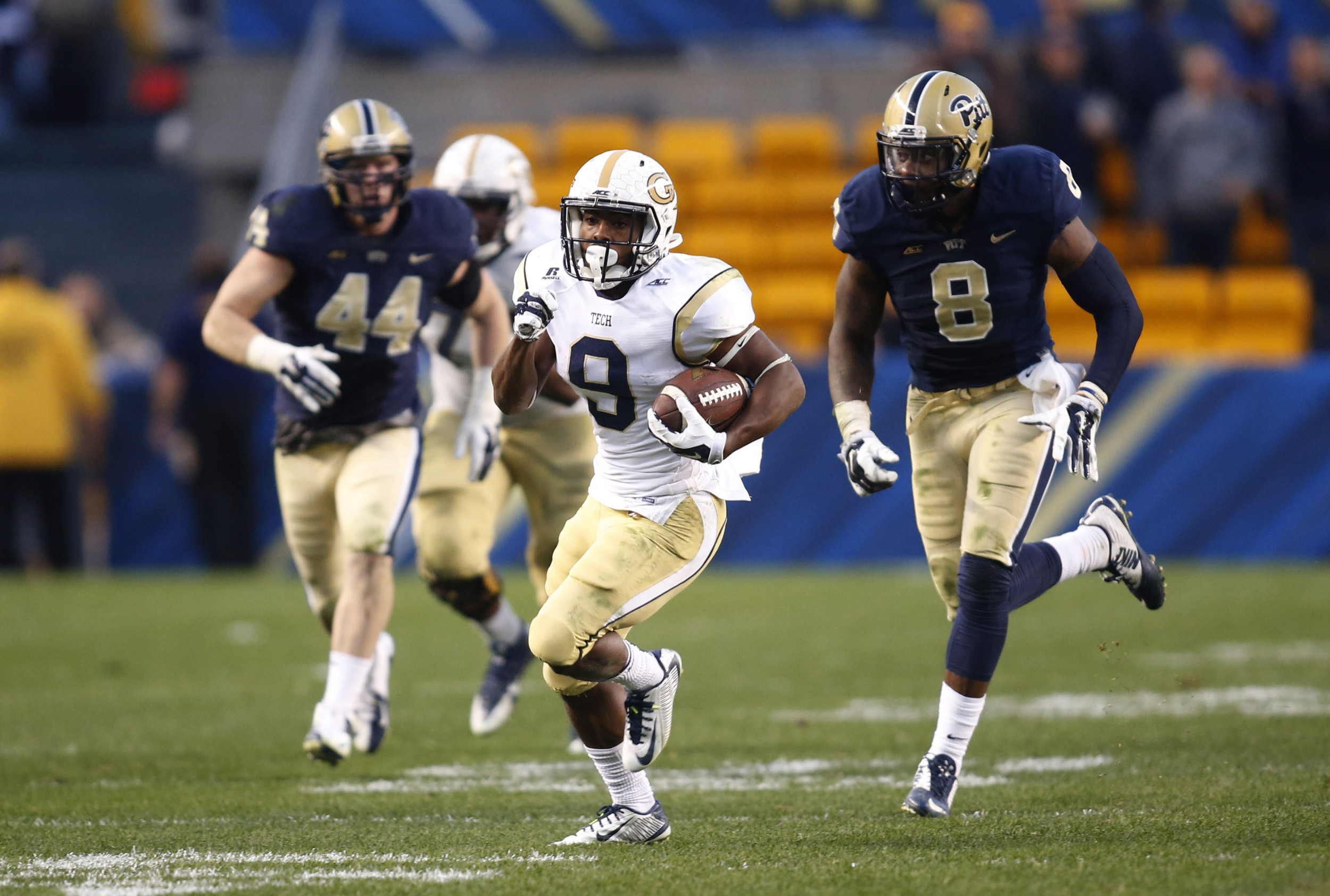 Oct 25, 2014; Pittsburgh, PA, USA; Yellow Jackets running back Tony Zenon (9) breaks away from the Pittsburgh Panthers defense on a fifty seven yard touchdown run during the fourth quarter. Charles LeClaire-USA TODAY Sports