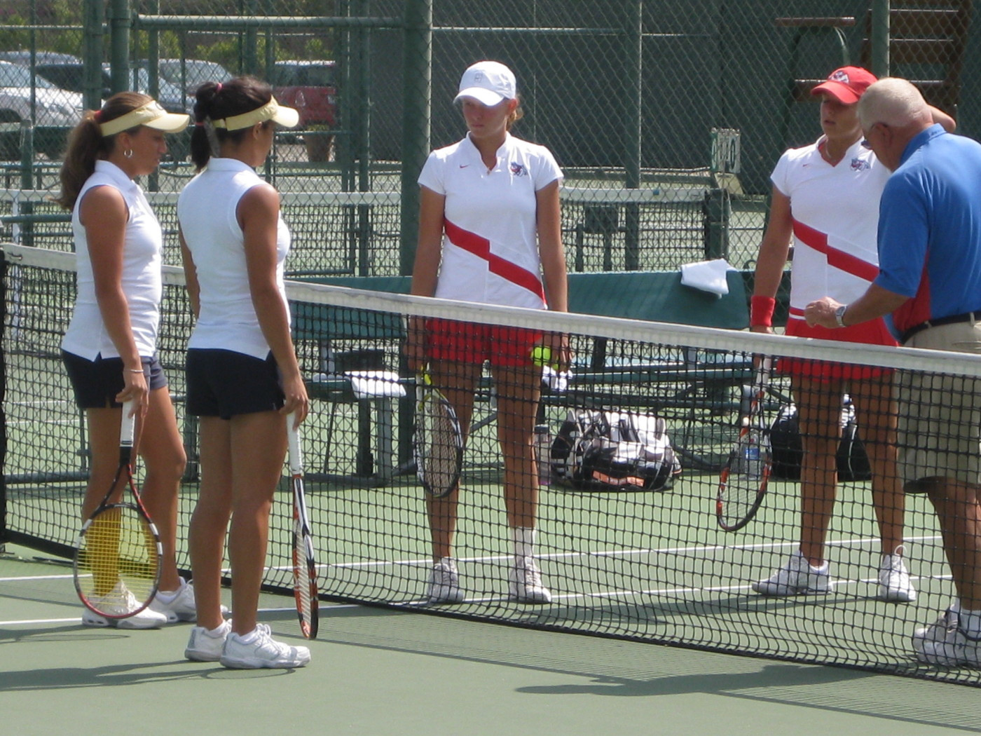 The team's meet at the net prior to the finals