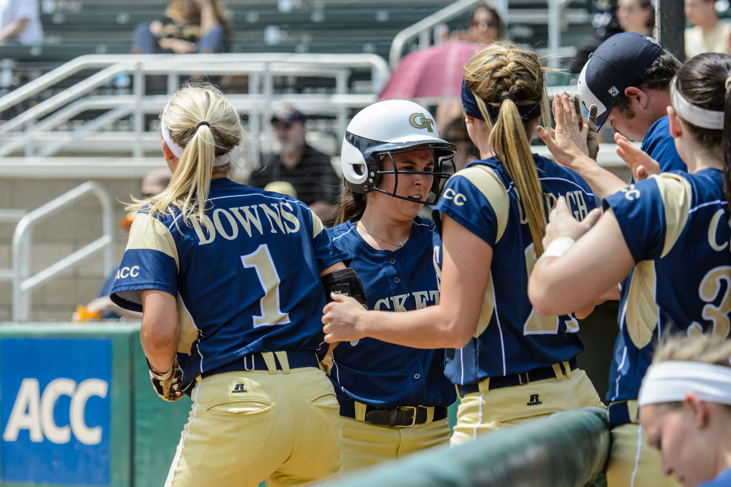 Chelsie Thomas (11) is welcomed back to the dugout after scoring