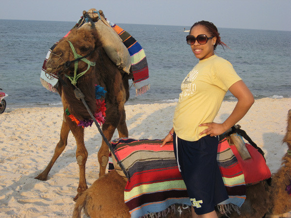 Iasia Hemingway with a camel on the beach