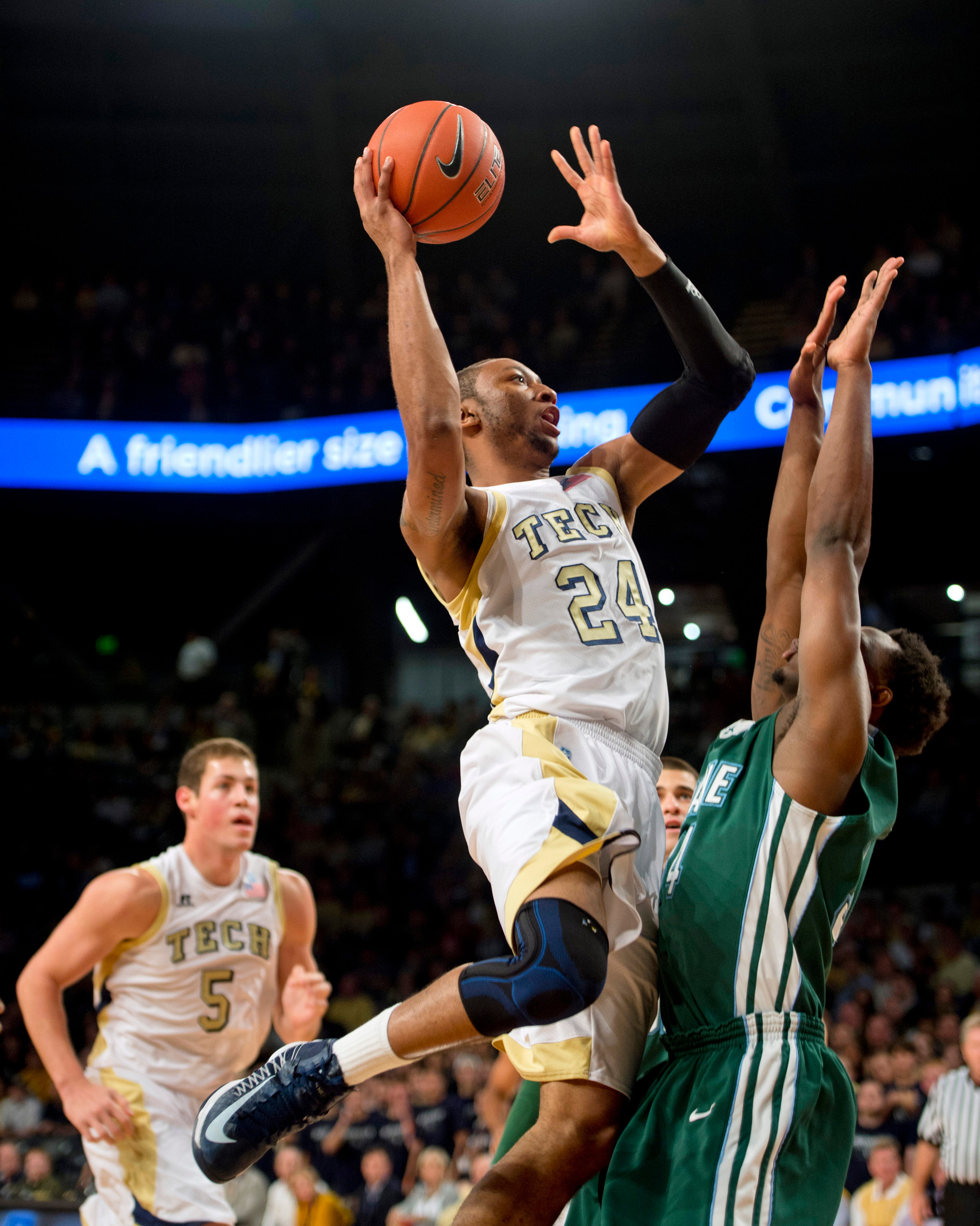 Georgia Tech forward Kammeon Holsey (24) takes a shot over Tulane forward forward Trevante Drye (34) during the first half. (AP Photo/Rich Addicks)