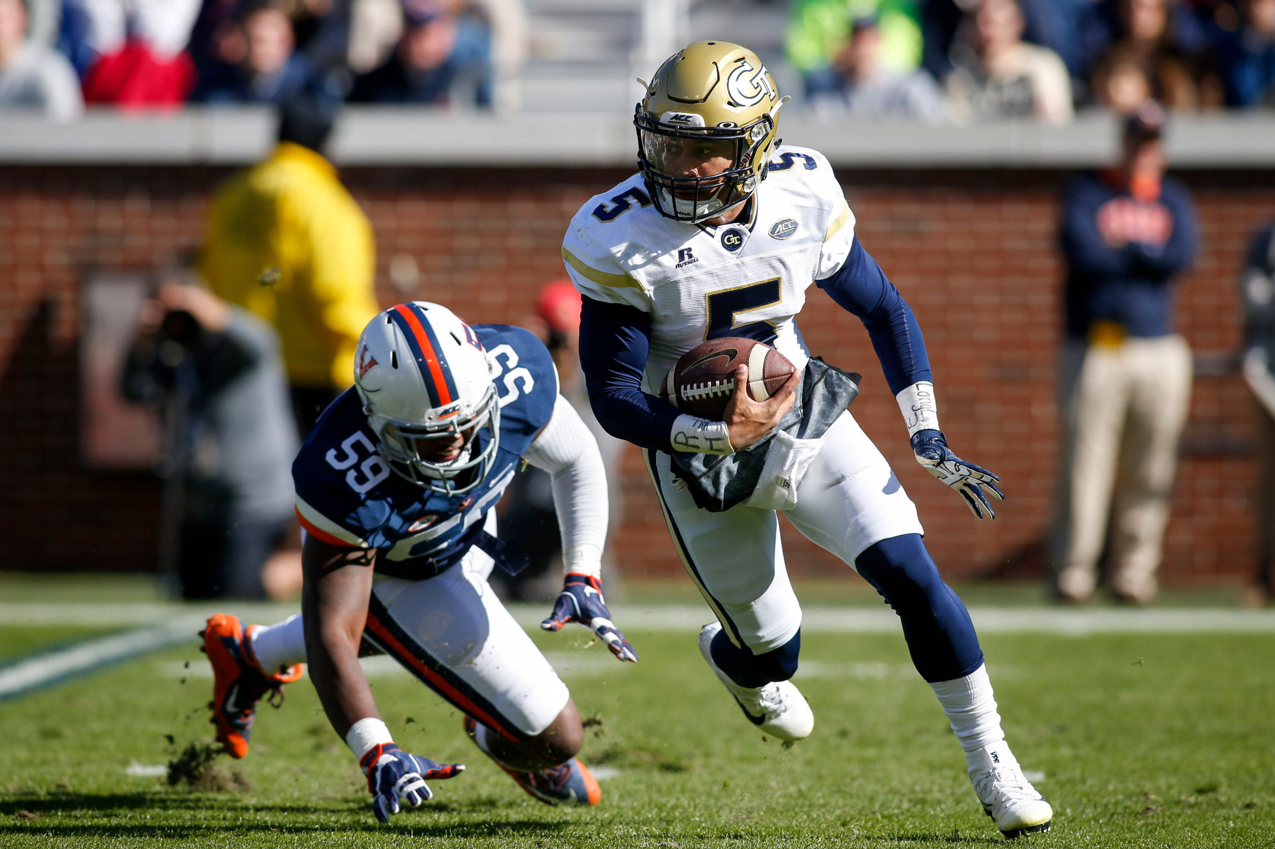 Yellow Jackets quarterback Justin Thomas (5) scrambles past Virginia Cavaliers defensive end Mark Hall (59) in the second quarter. Brett Davis-USA TODAY Sports