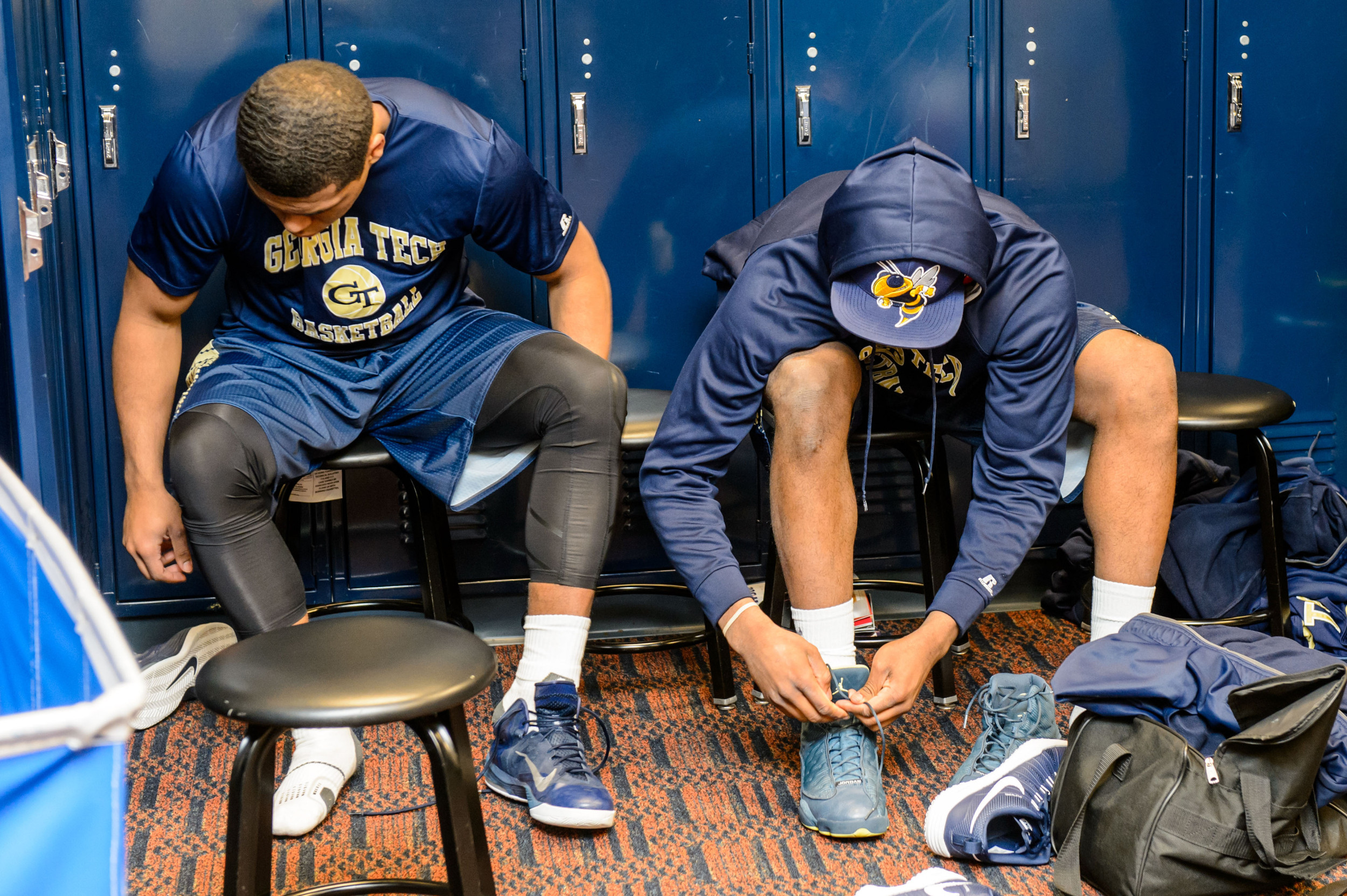 Marcus Georges-Hunt (3) and Corey Heyward (5) lace up their shoes for warm ups.