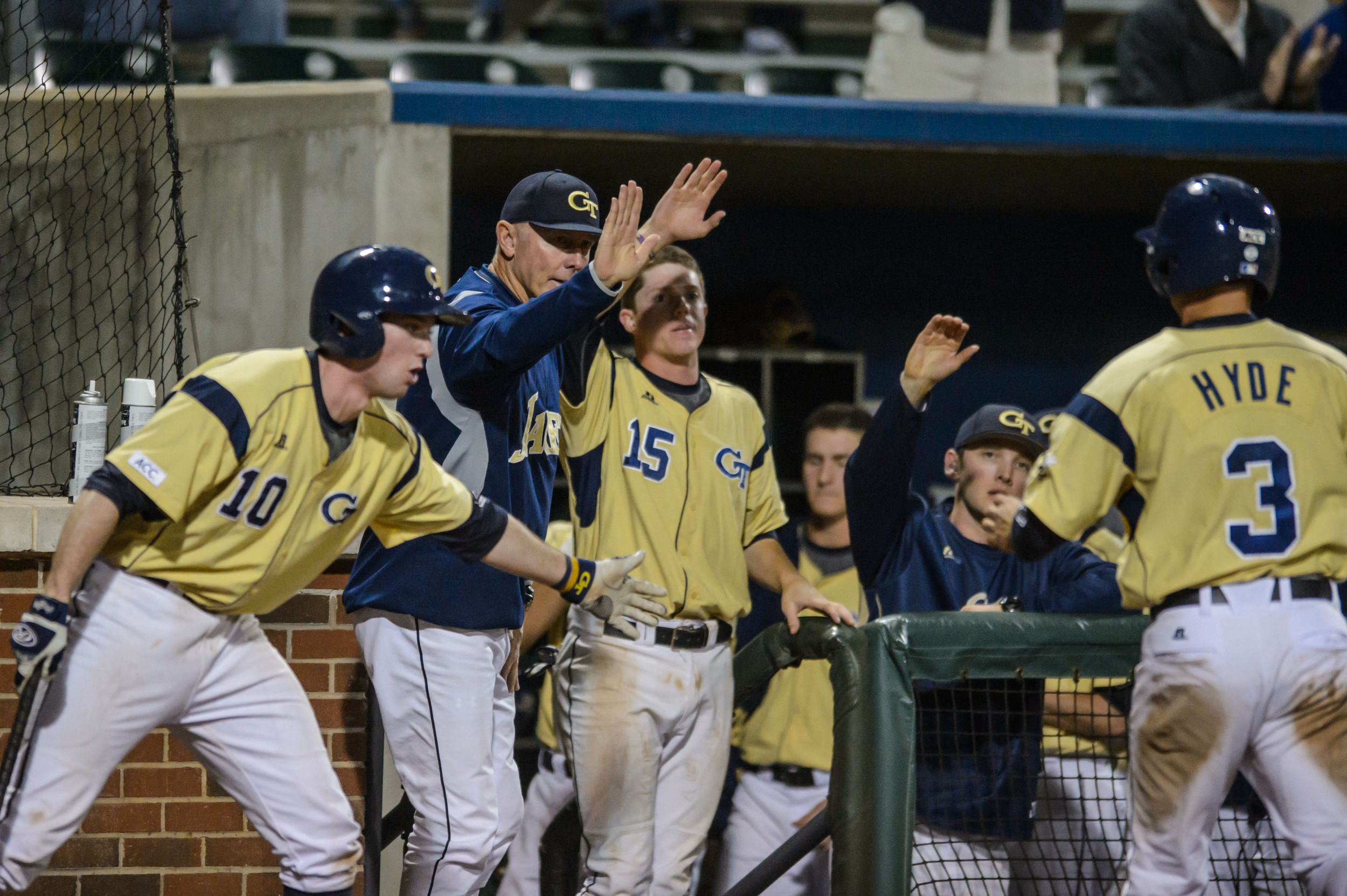 Coach Danny Hall, Brandon Gold, Connor Justus and Eddie Prasch welcome Mott Hyde back to the dugout after his game-tying run.