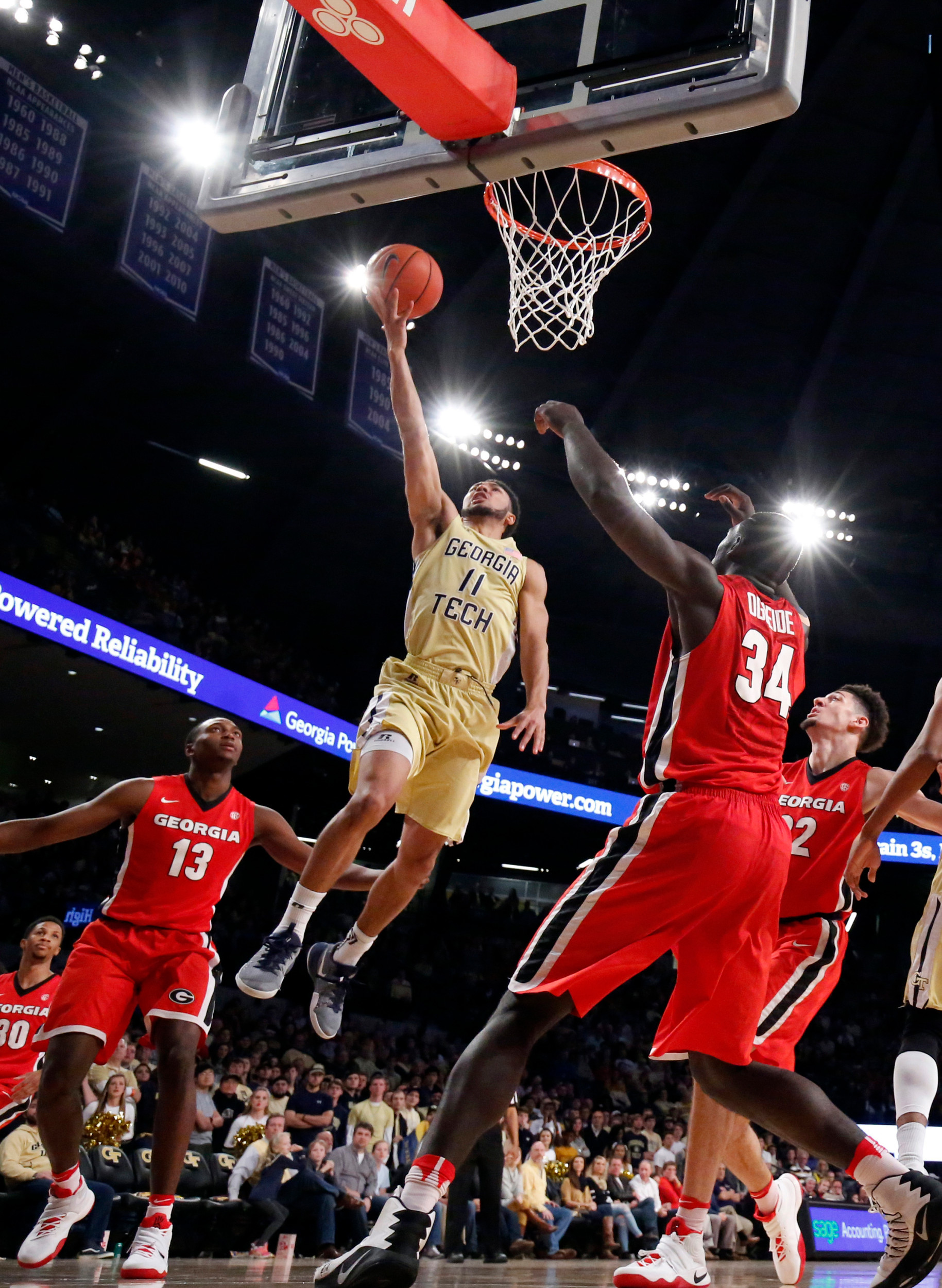 Josh Heath (11) attempts a shot against Georgia Bulldogs forward E'Torrion Wilridge (13) and forward Derek Ogbeide (34) in the second half of their game at McCamish Pavilion. Georgia won 60-43. Jason Getz-USA TODAY Sports