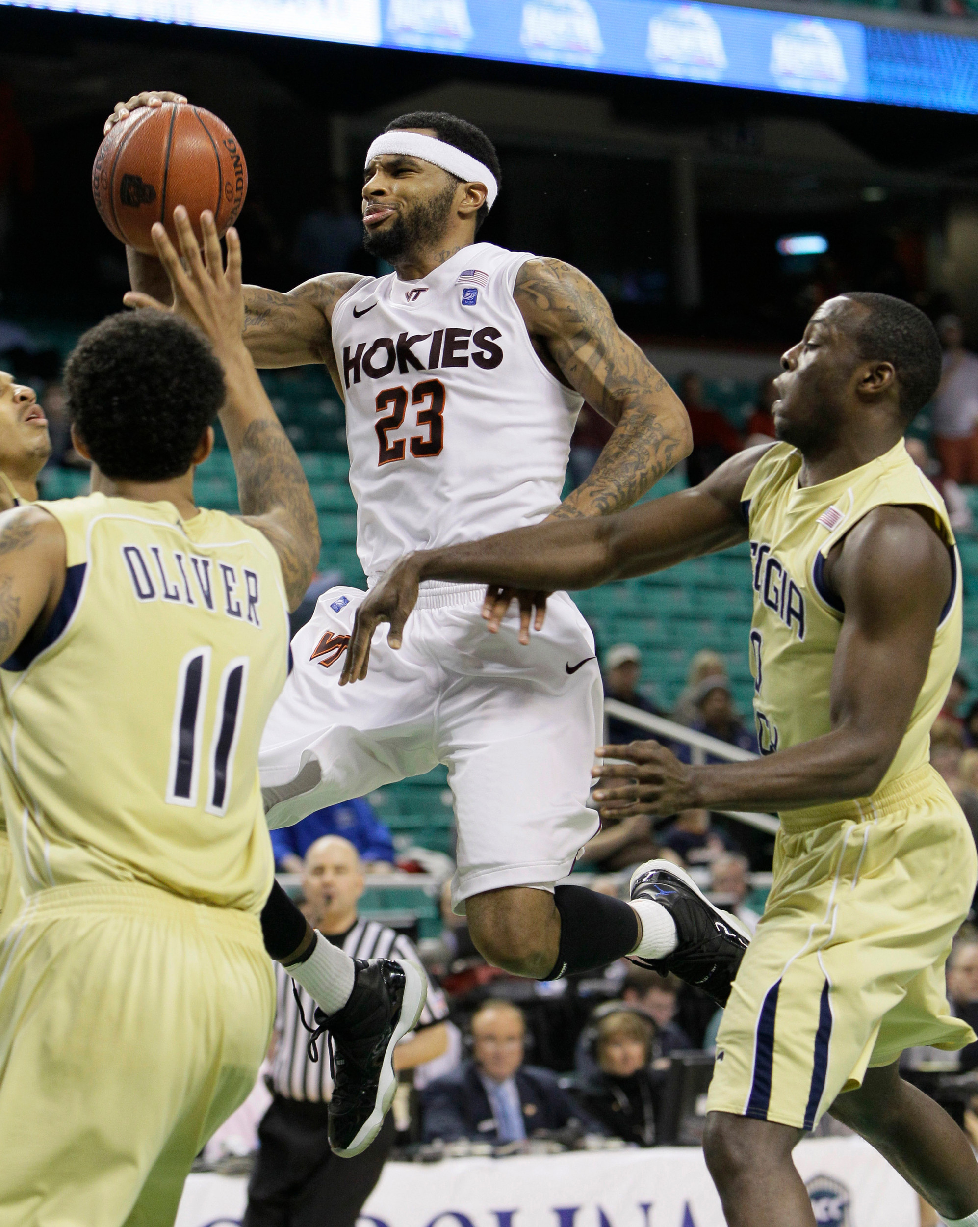 Virginia Tech's Malcolm Delaney drives past Georgia Tech's Brian Oliver and Mfon Udofia, right, in the second half of Virginia Tech's win. (AP Photo/Gerry Broome)