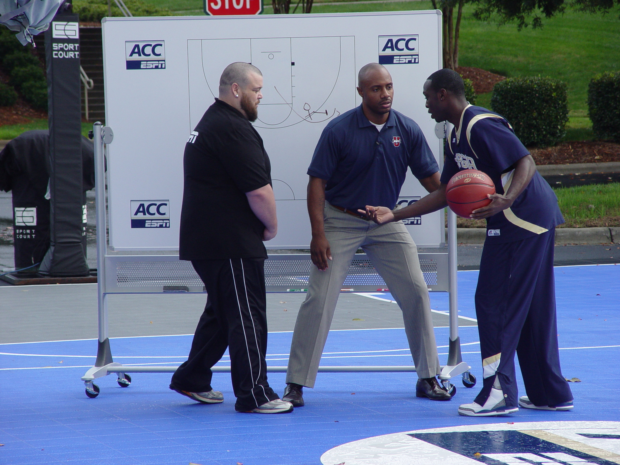 Mfon Udofia demonstrates a play for ESPNU's Jay Williams at ACC Operation Basketball, October 19, 2011