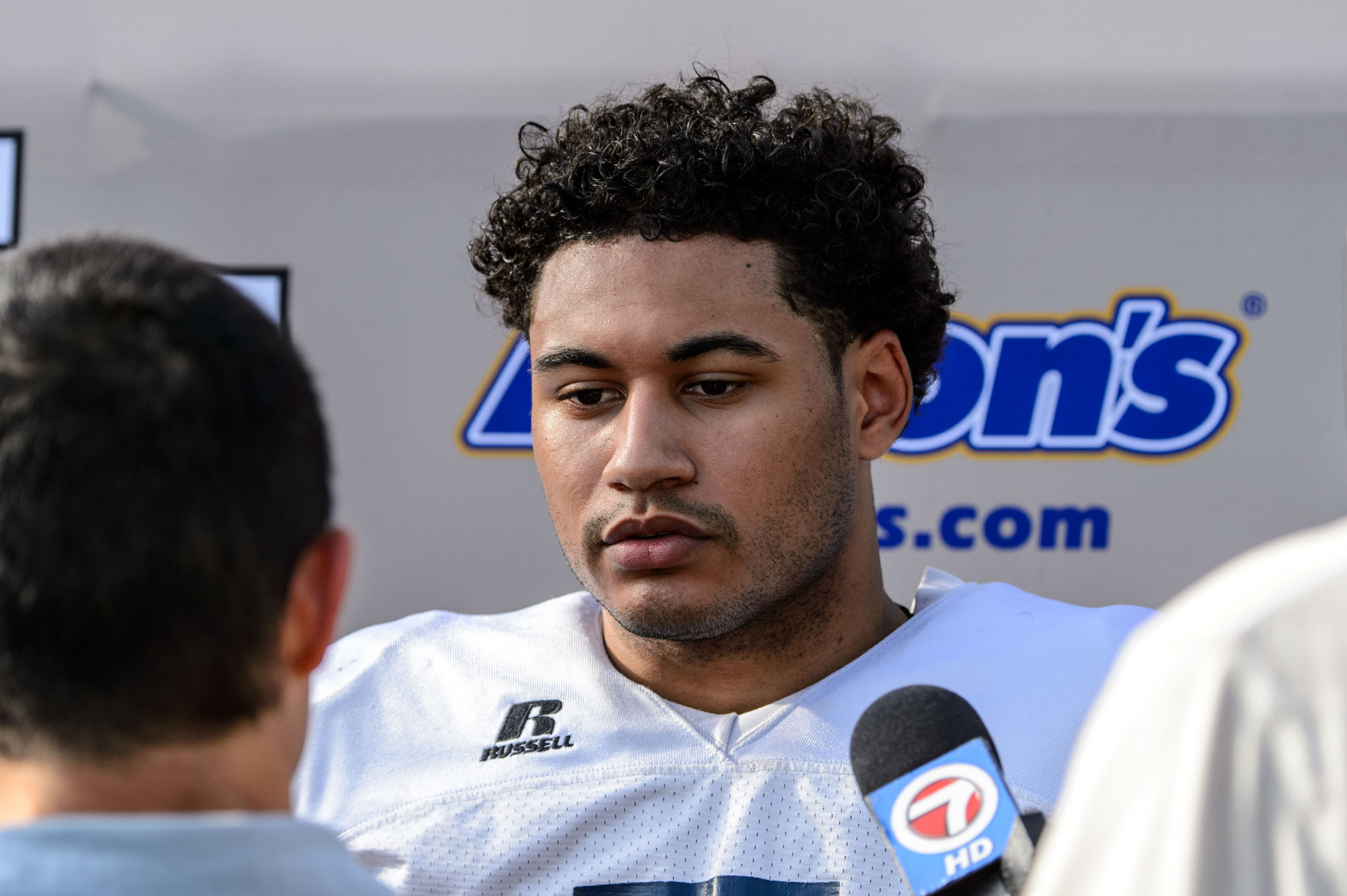 Justin Thomas (5) talks with the media after practice
