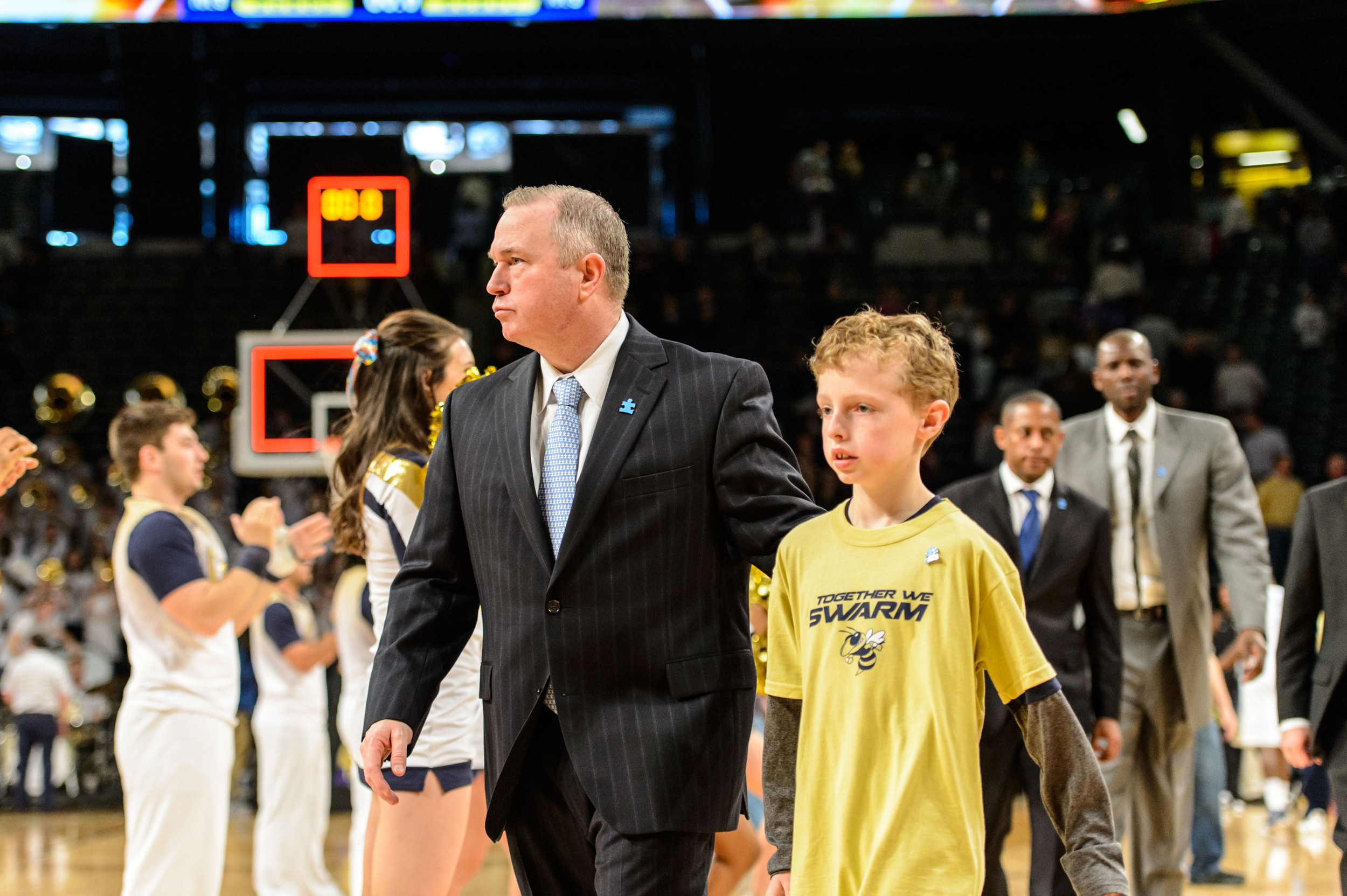 Assistant Coach Tom Herrion and his son Robert leave the court together after the game