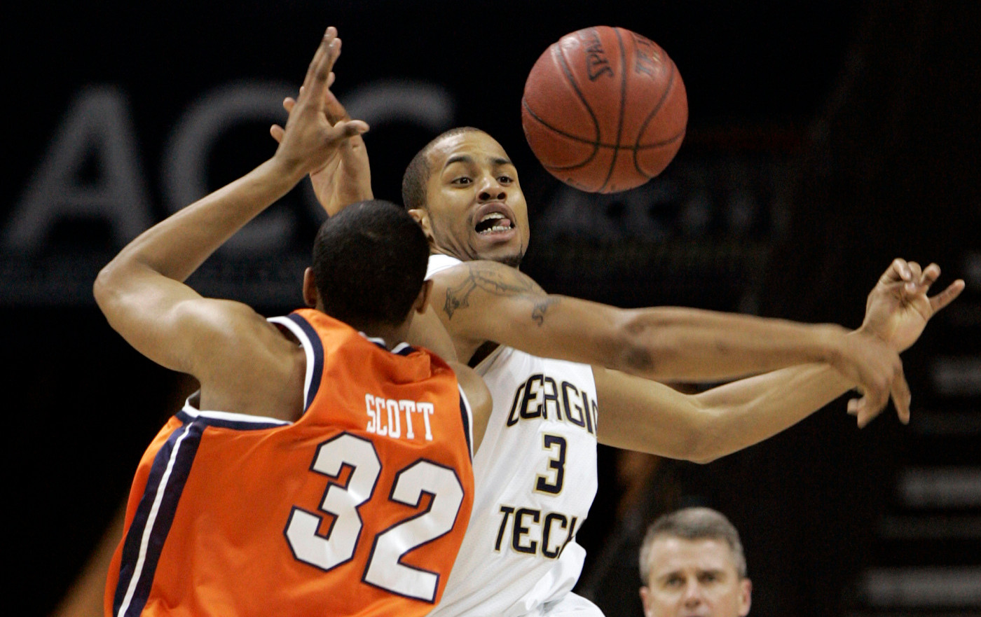 Georgia Tech's Maurice Miller, right, and Virginia's Mike Scott fight for a loose ball during the first half of an ACC men's basketball tournament game at Bobcats Arena in Charlotte, N.C., Thursday, March 13, 2008. (AP Photo/Steve Helber)
