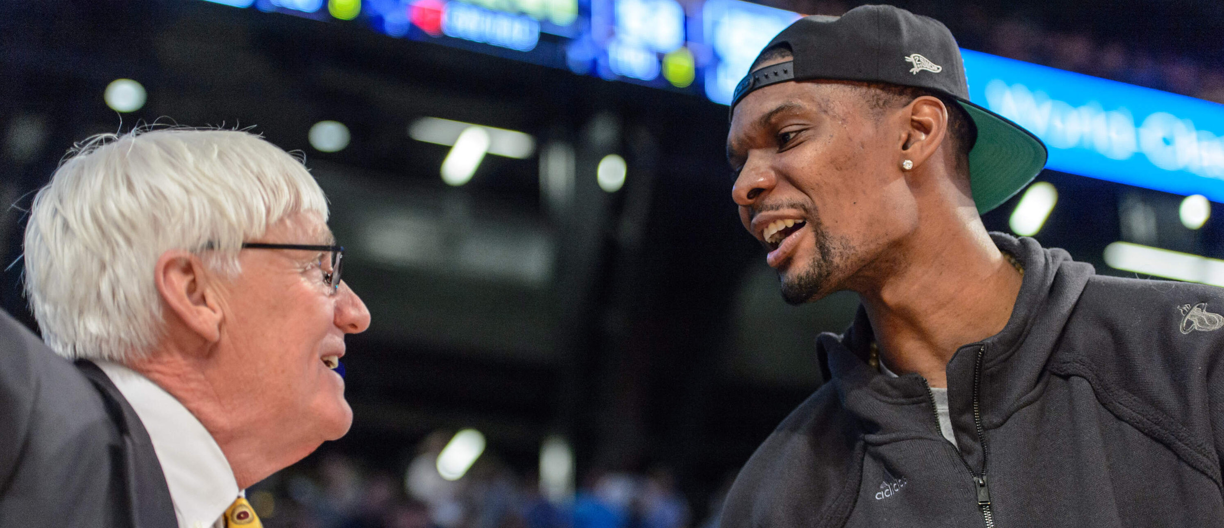 Chris Bosh speaks to Bobby Cremins during the game.