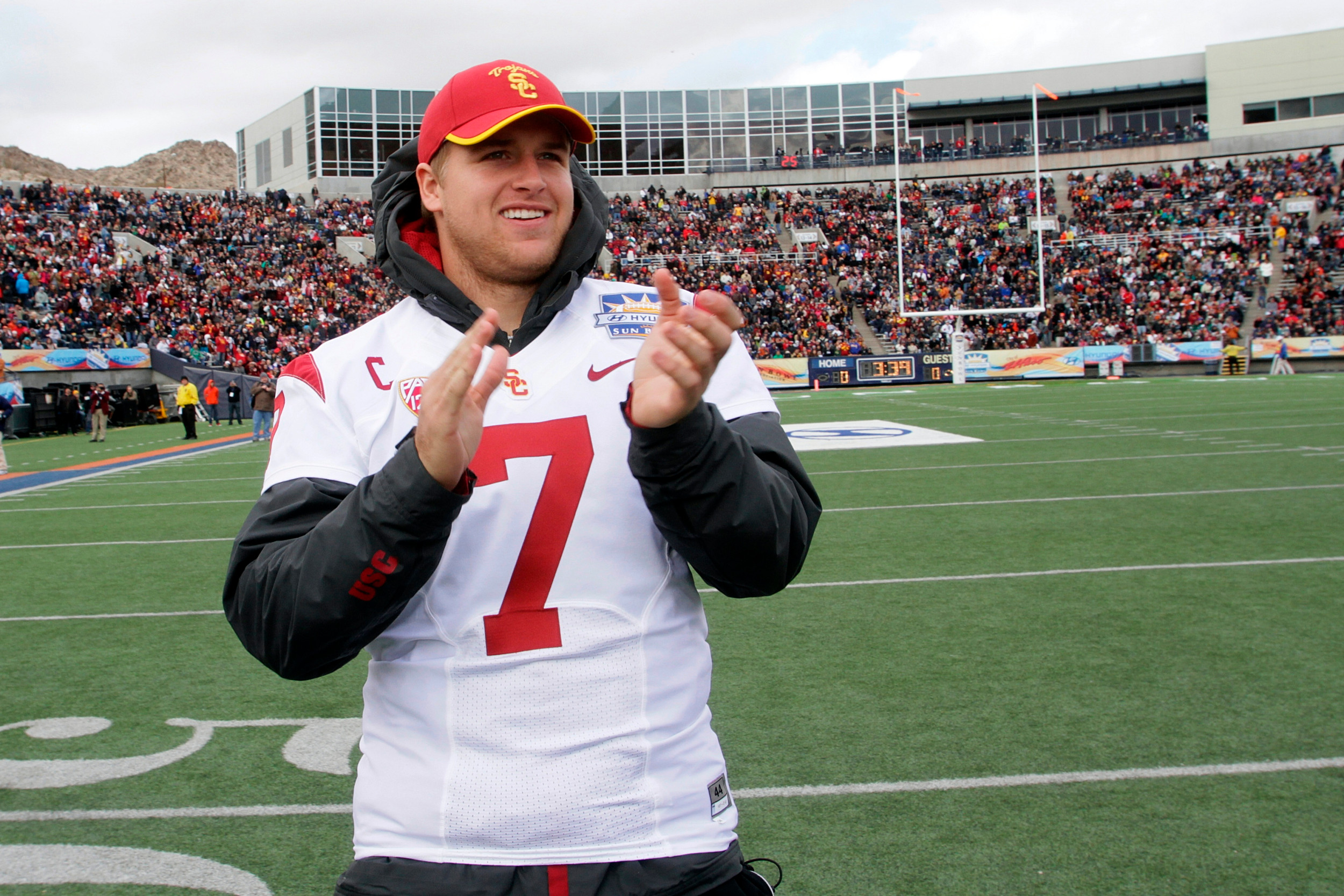Injured Southern California quarterback Matt Barkley claps for his team as they take the field to play Georgia Tech in the Sun Bowl NCAA college football game, Monday, Dec. 31, 2012, in El Paso, Texas. Georgia Tech won 21-7. (AP Photo/Mark Lambie)