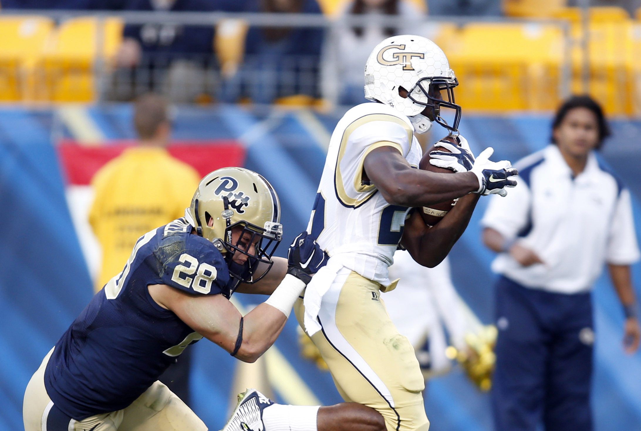 Oct 25, 2014; Pittsburgh, PA, USA; Yellow Jackets running back Broderick Snoddy (22) scores a twenty eight yard touchdown past Pittsburgh Panthers linebacker Anthony Gonzalez (28) during the third quarter. Charles LeClaire-USA TODAY Sports